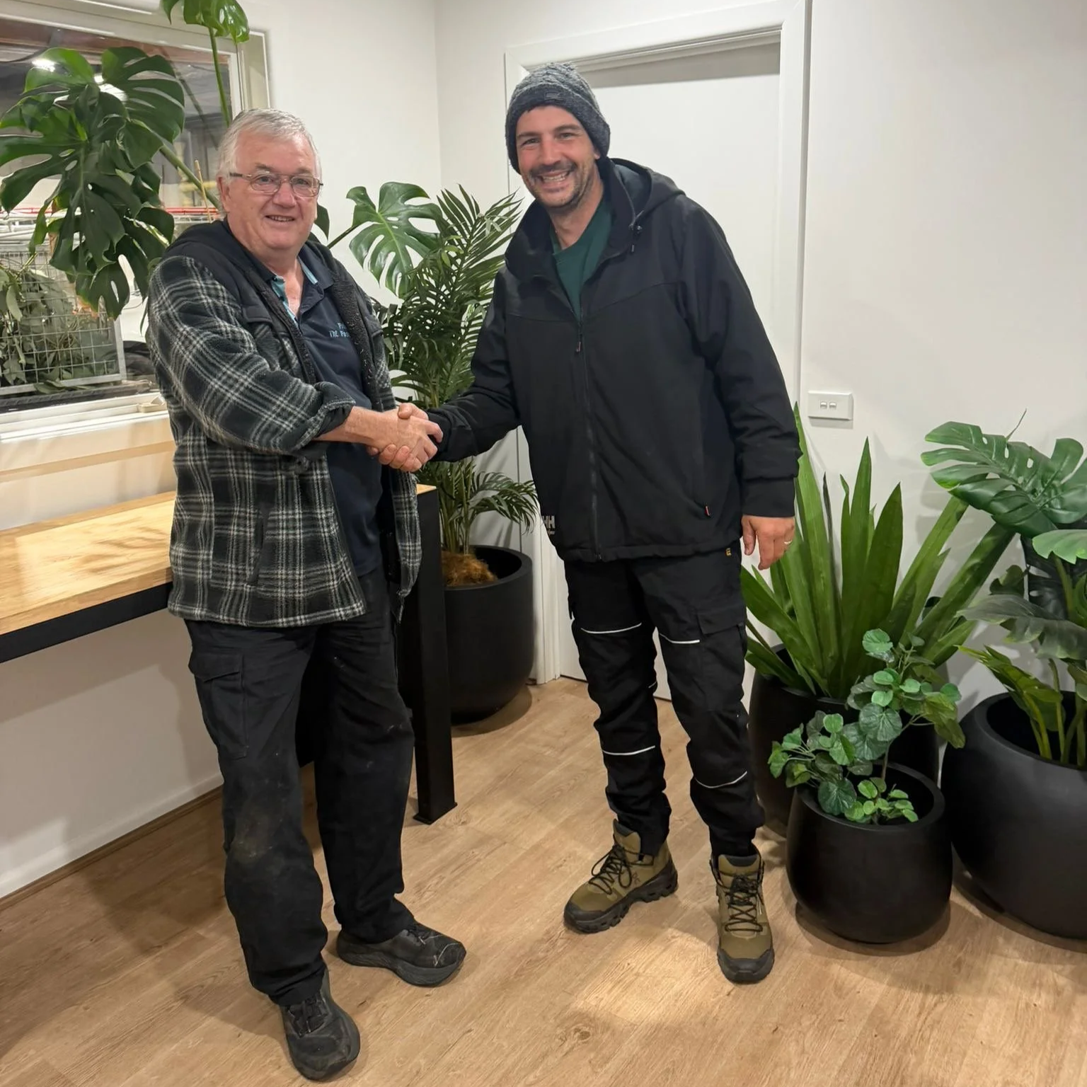 Ryan & Phil shaking hands celebrating the acquisition of Phil the Pool Man and the start of Modern Pool Care
