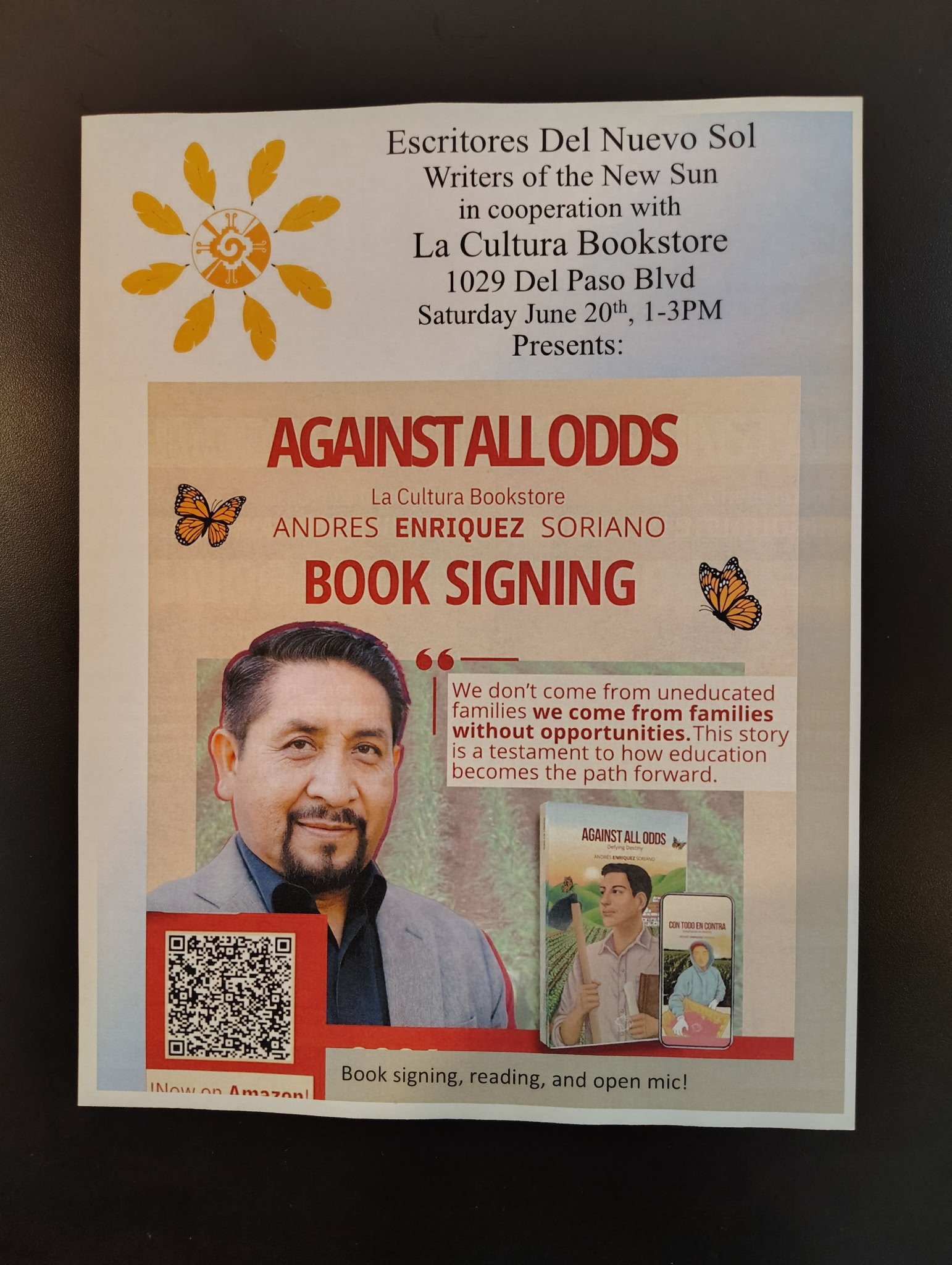 A flyer for a book signing event featuring author Andres Enriquez Soriano, with the event details including date, time, location, and promotional graphics such as a QR code, butterflies, and images of the book and people.