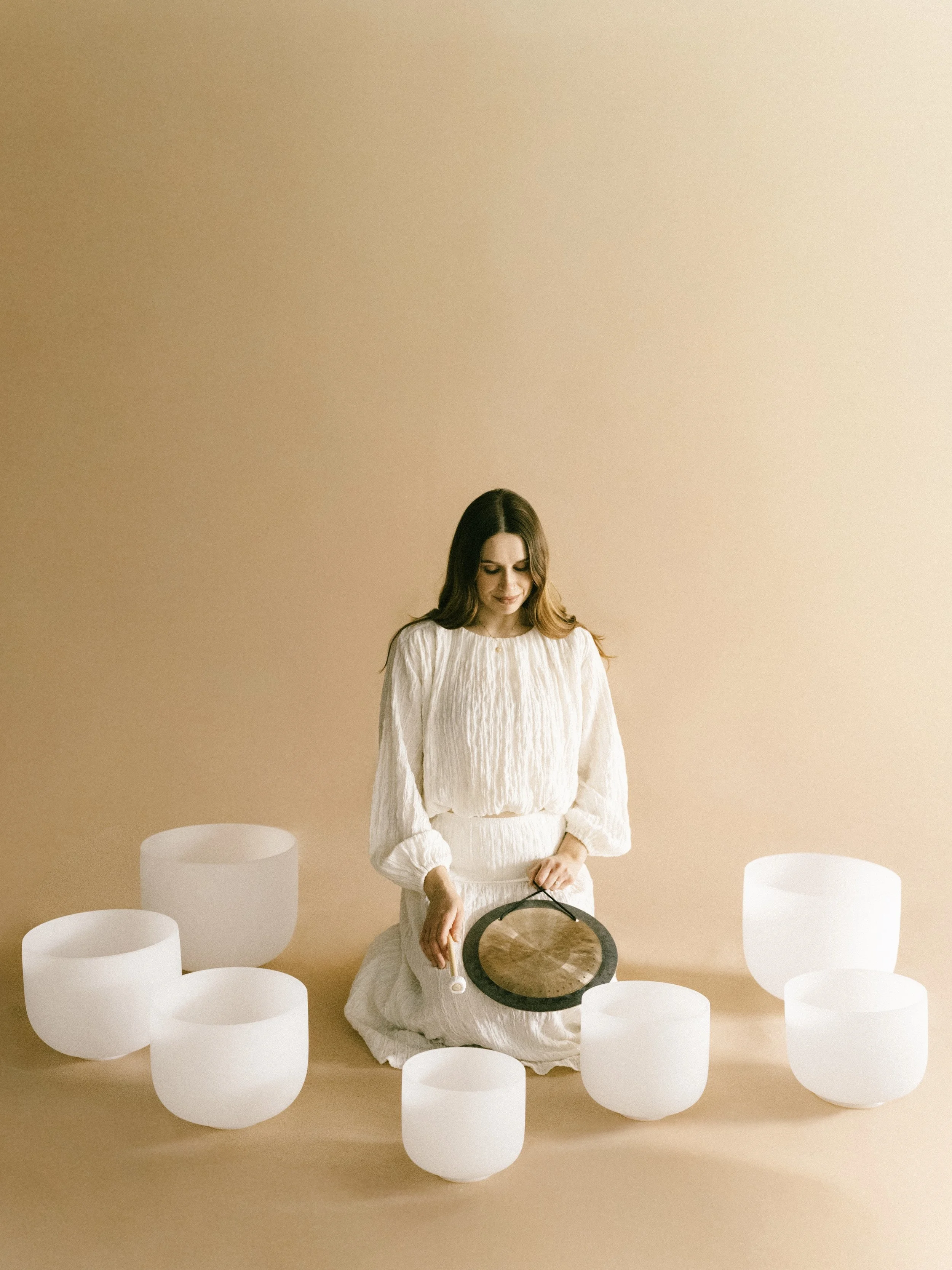 Hannah of Holistic Han Sound Healing leading an immersive crystal singing bowl sound bath in Monterey Bay.
