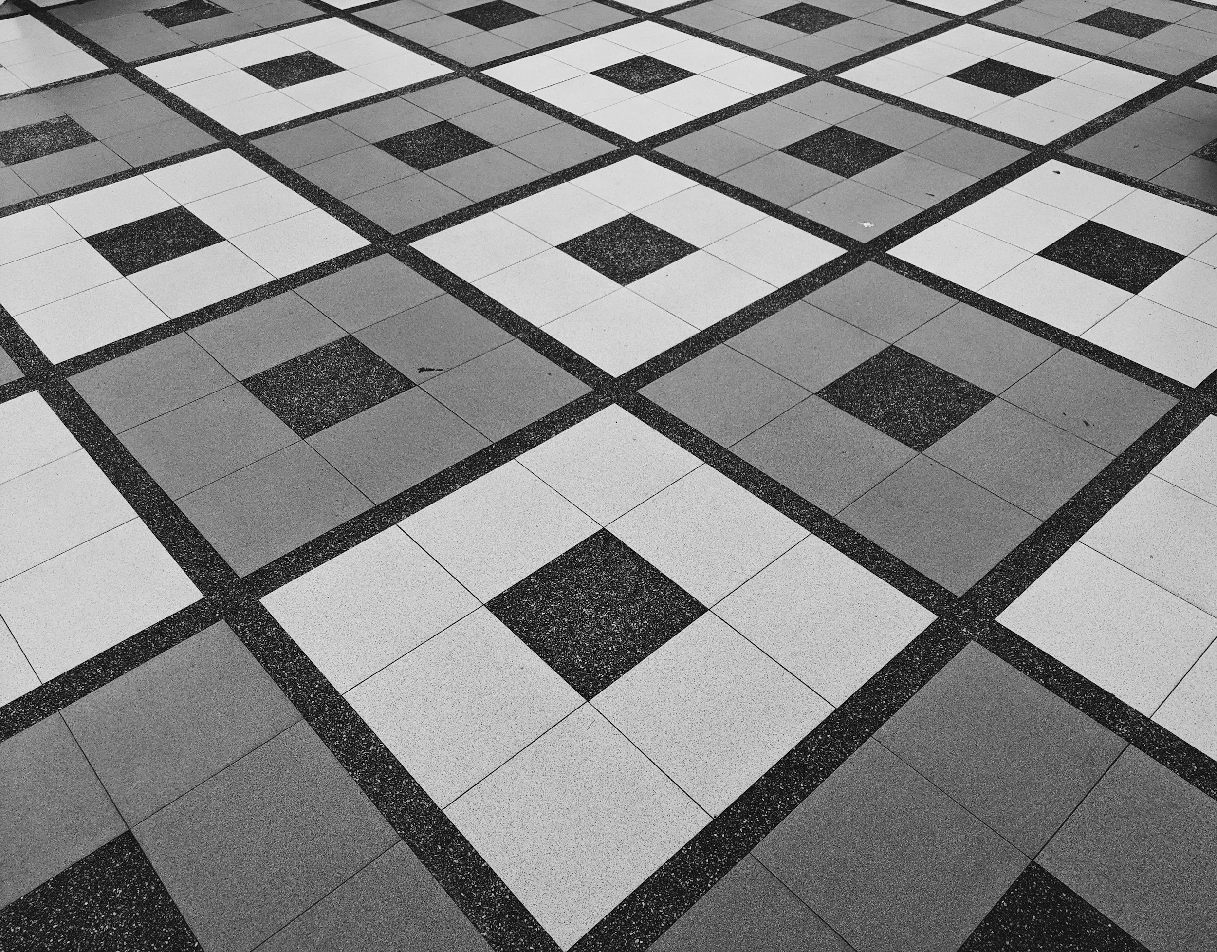 Black and white checkered tile floor with dark grout lines.