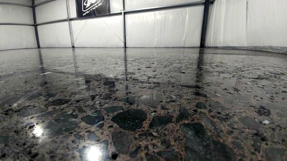 Professional concrete process creating a sleek, polished concrete surface with a smooth finish, enhanced durability, and a modern appearance for garages, commercial spaces, and industrial floors