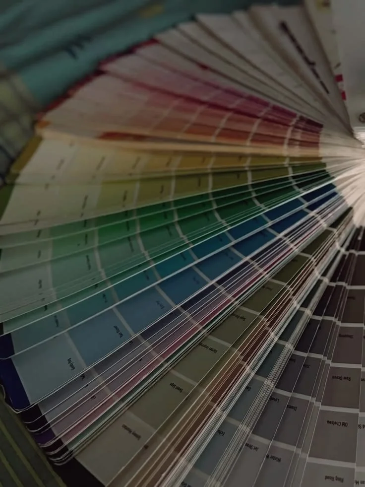 Display of colorful paint swatches or color samples arranged in overlapping fans.