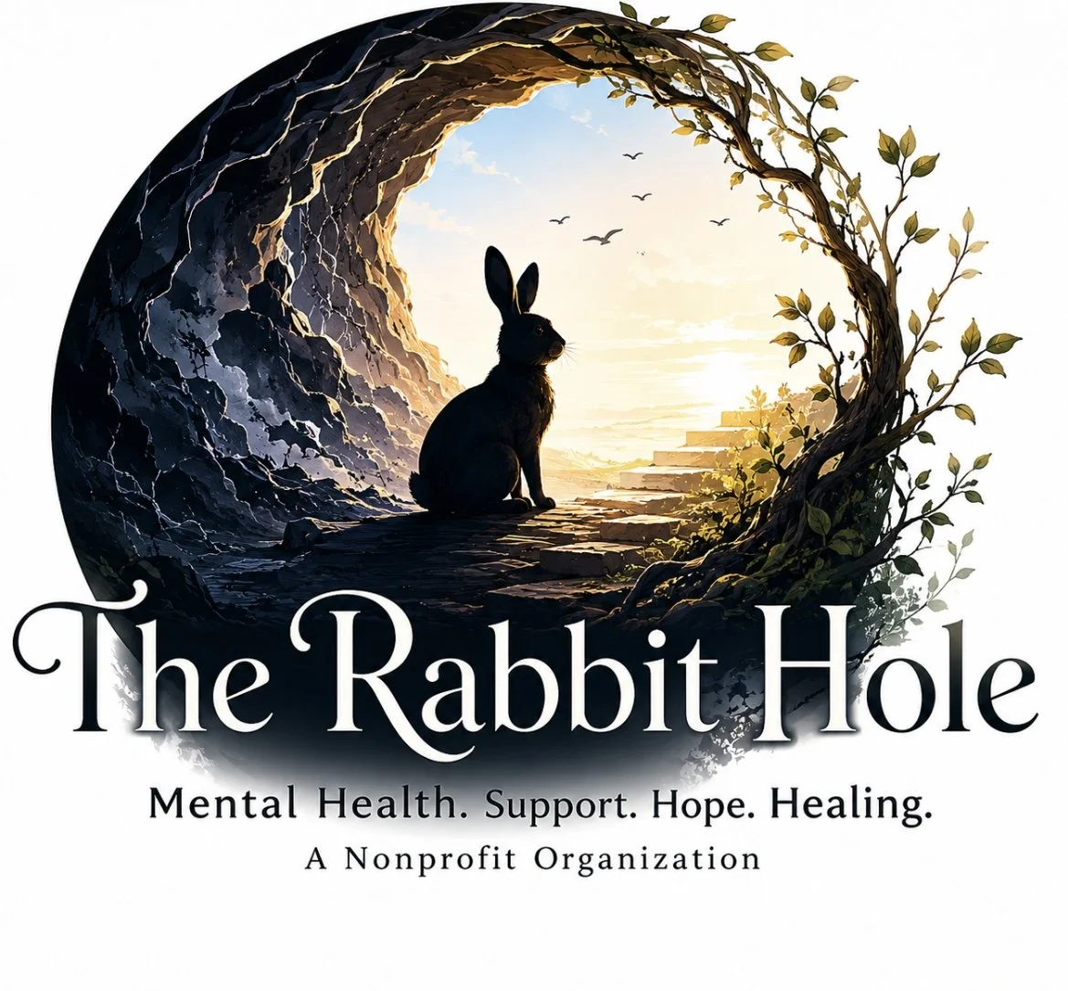 A logo for 'The Rabbit Hole' nonprofit organization featuring a silhouette of a rabbit sitting inside a cave with an opening showing a sunrise or sunset, stairs leading upward and a tree branch with leaves framing the scene. The tagline reads 'Mental Health. Support. Hope. Healing.'