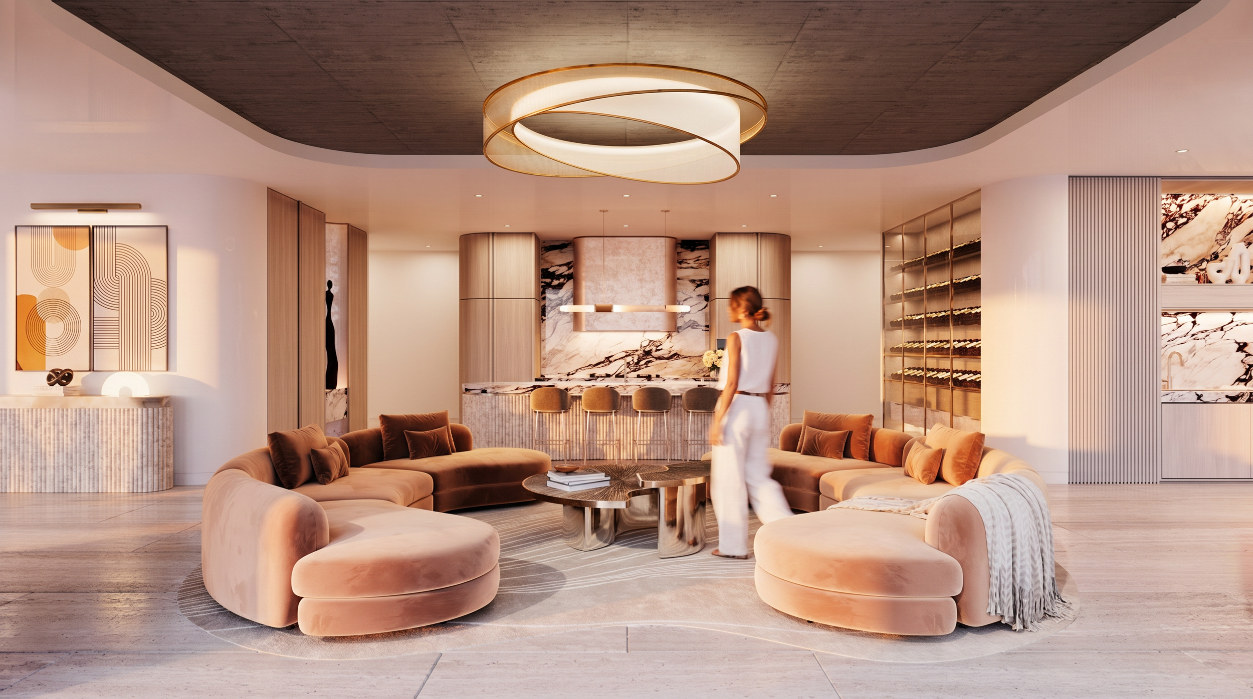 Modern living room with beige sofas, wooden coffee table, and bar area in the background with bar stools. Decor includes abstract artwork and a large circular ceiling light fixture. A person in white outfit walking through the space.