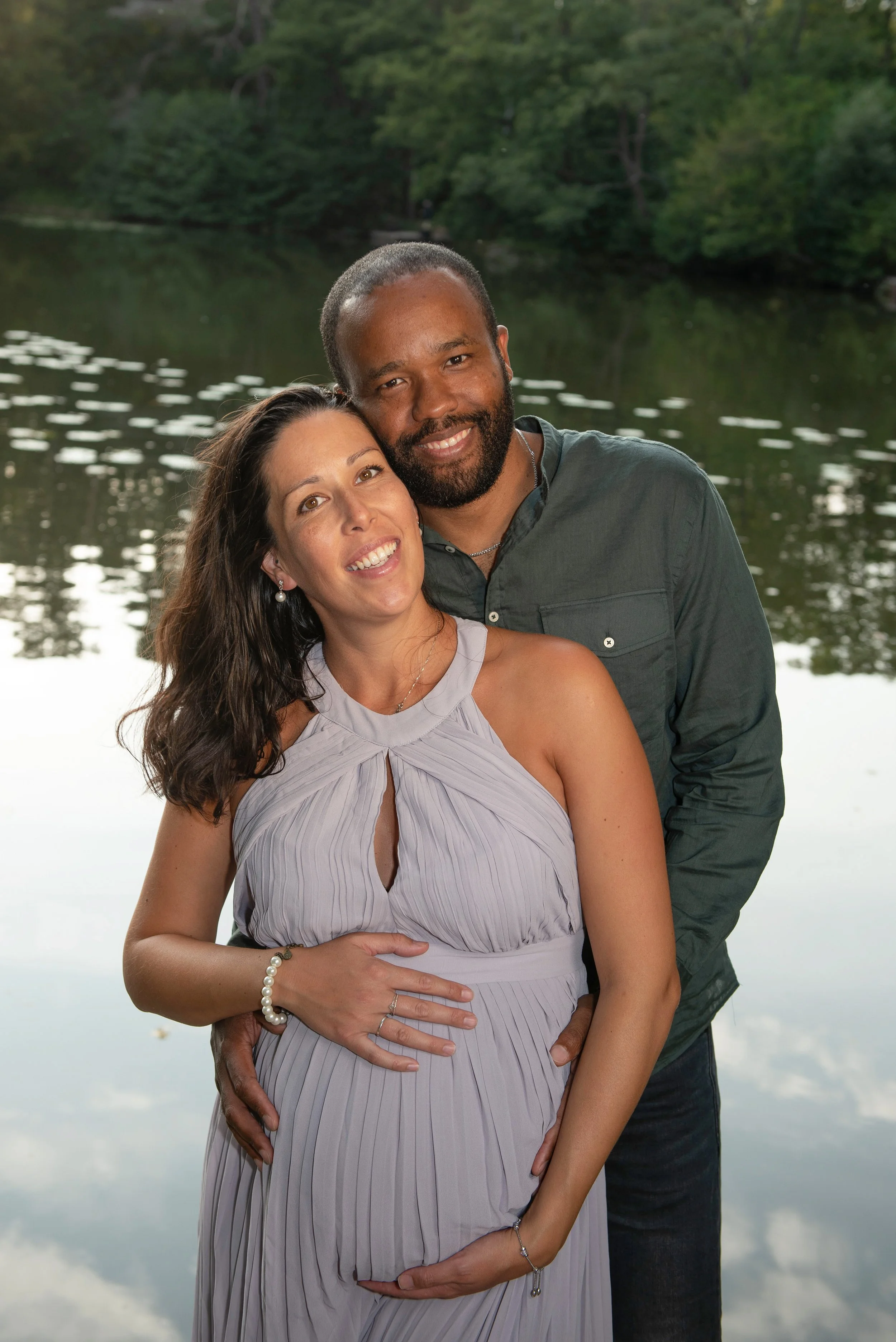 a relaxed couple standing by the lake