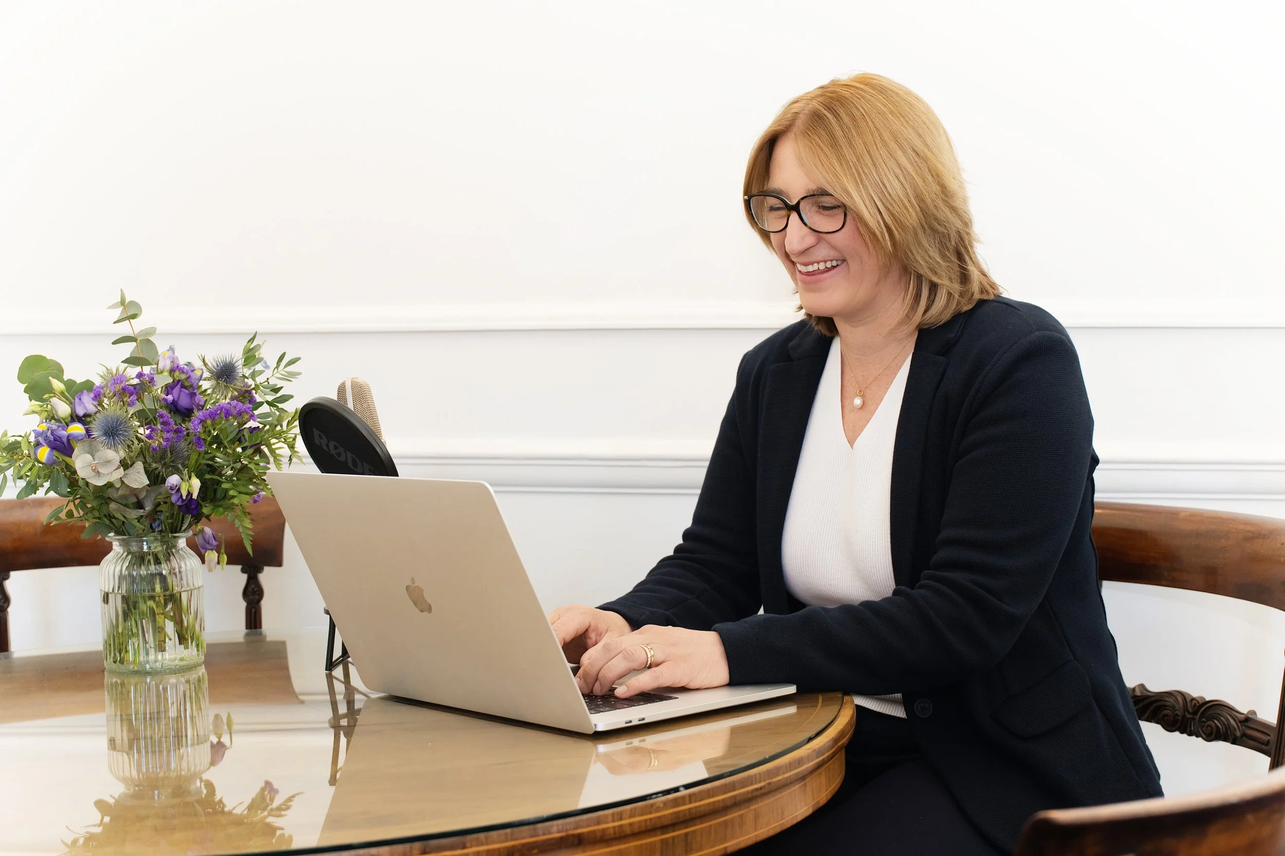 a lady taking a booking and greeting a client