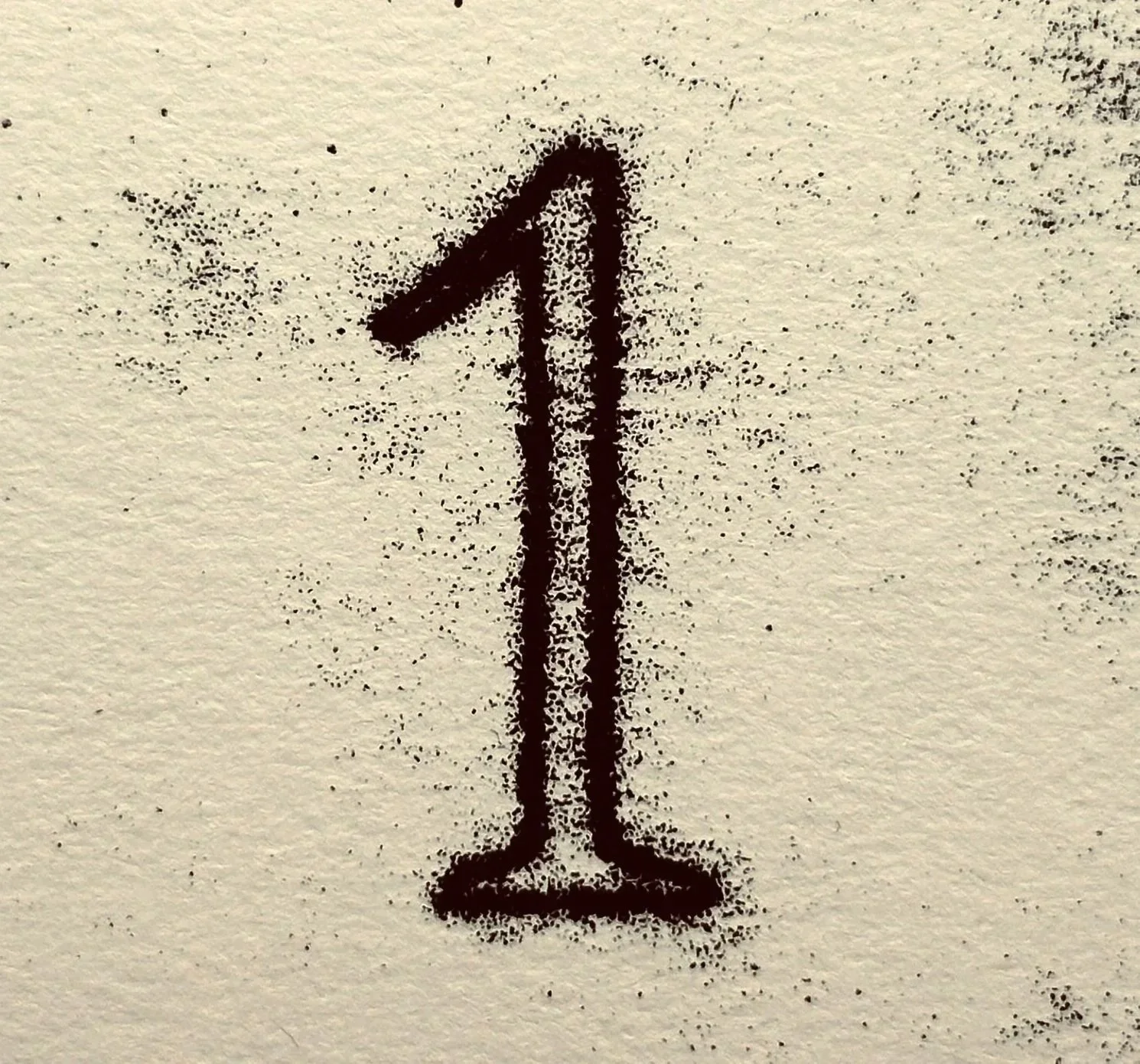 A black spray-paint drawing of a wine glass on a beige textured surface.