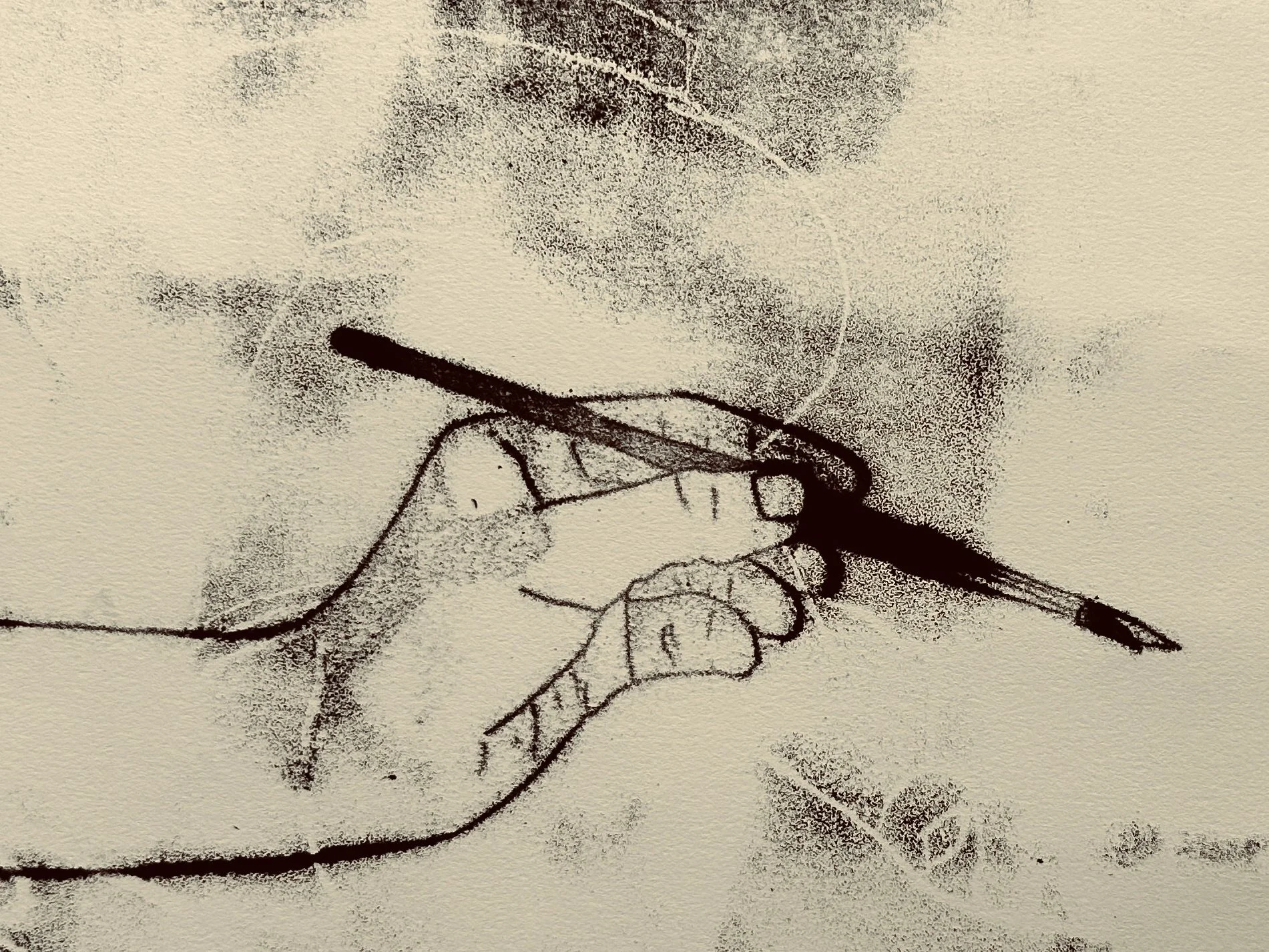 A hand holds a medium-sized paintbrush.