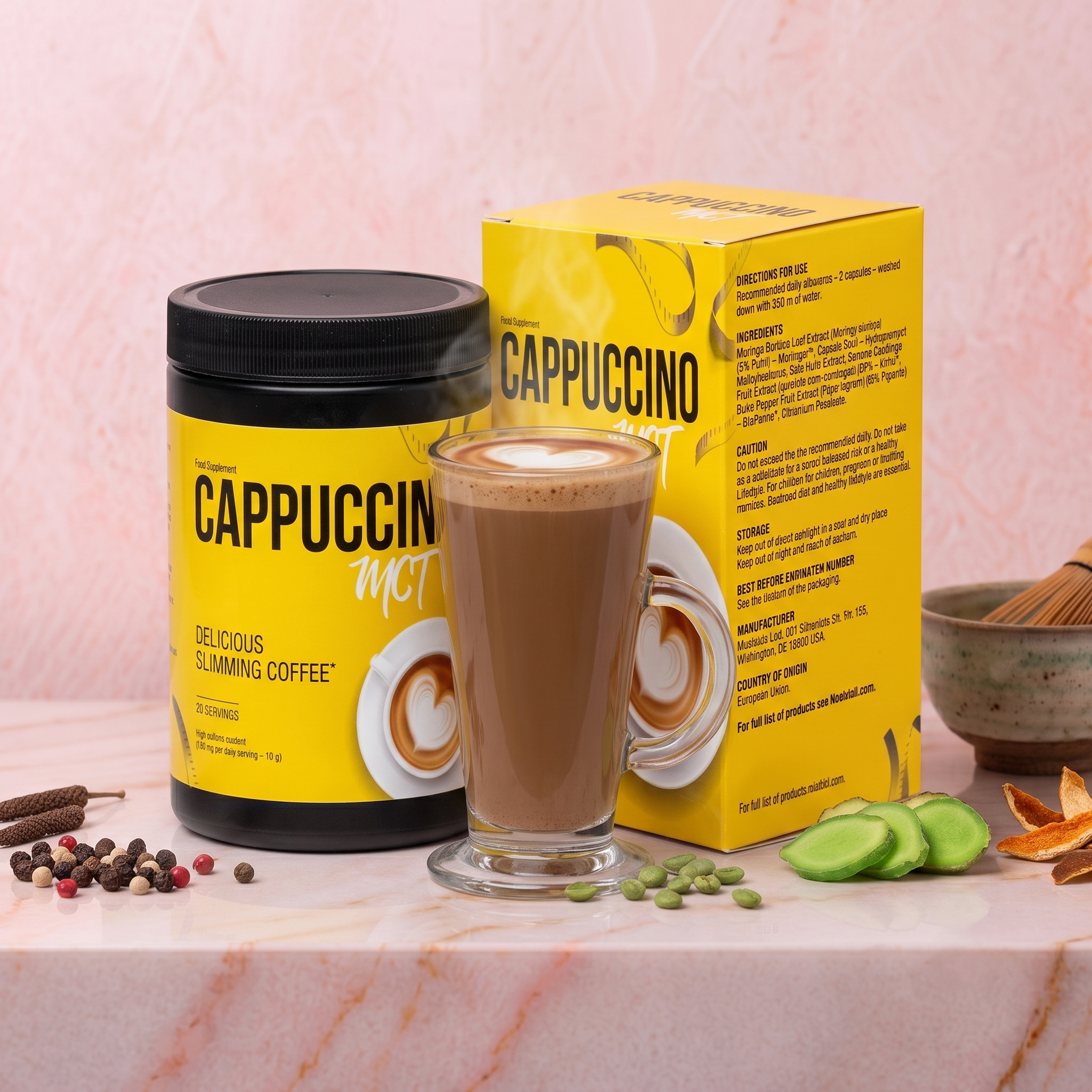 A yellow box of cappuccino mix, a cup of prepared cappuccino, and assorted candies and peppercorns arranged on a white marble surface with a light pink marble background.