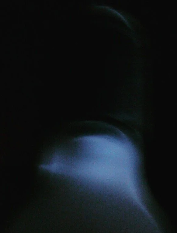 Not every presence seeks visibility. Emerging from darkness, the form refuses to become fully identifiable, remaining suspended between appearance and disappearance. The image does not conceal reality; it exposes the limits of perception itself. What