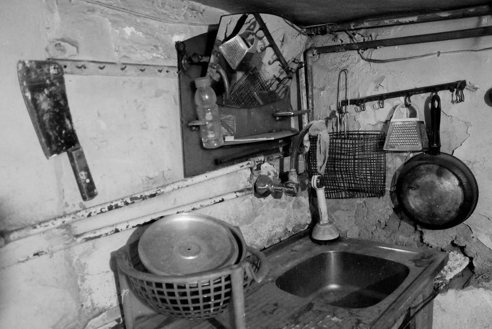Nothing here asks to be remembered, yet everything remembers. The utensils, stains, rust, and broken surfaces form a language without a speaker. The room becomes an archaeology of gestures, where absence accumulates more densely than presence, and th