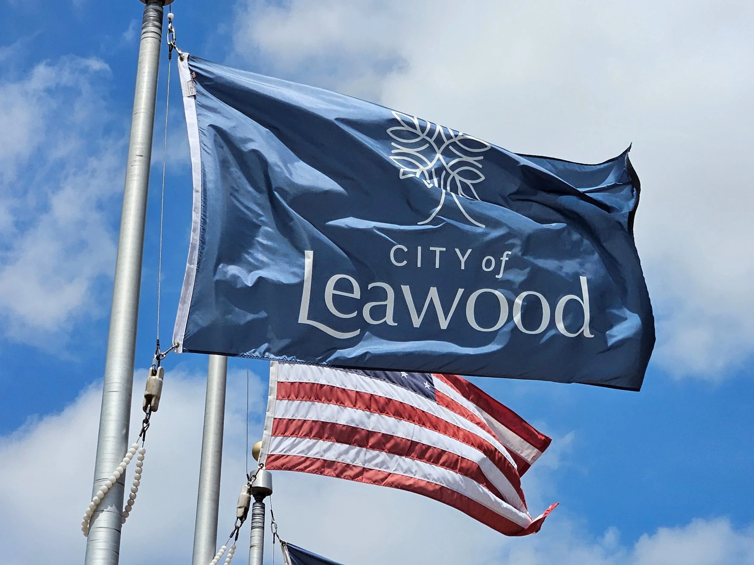 The beautiful  flags fluttering outside the Leawood City Hall. Permits add value to luxury home remodeling in Leawood Kansas.