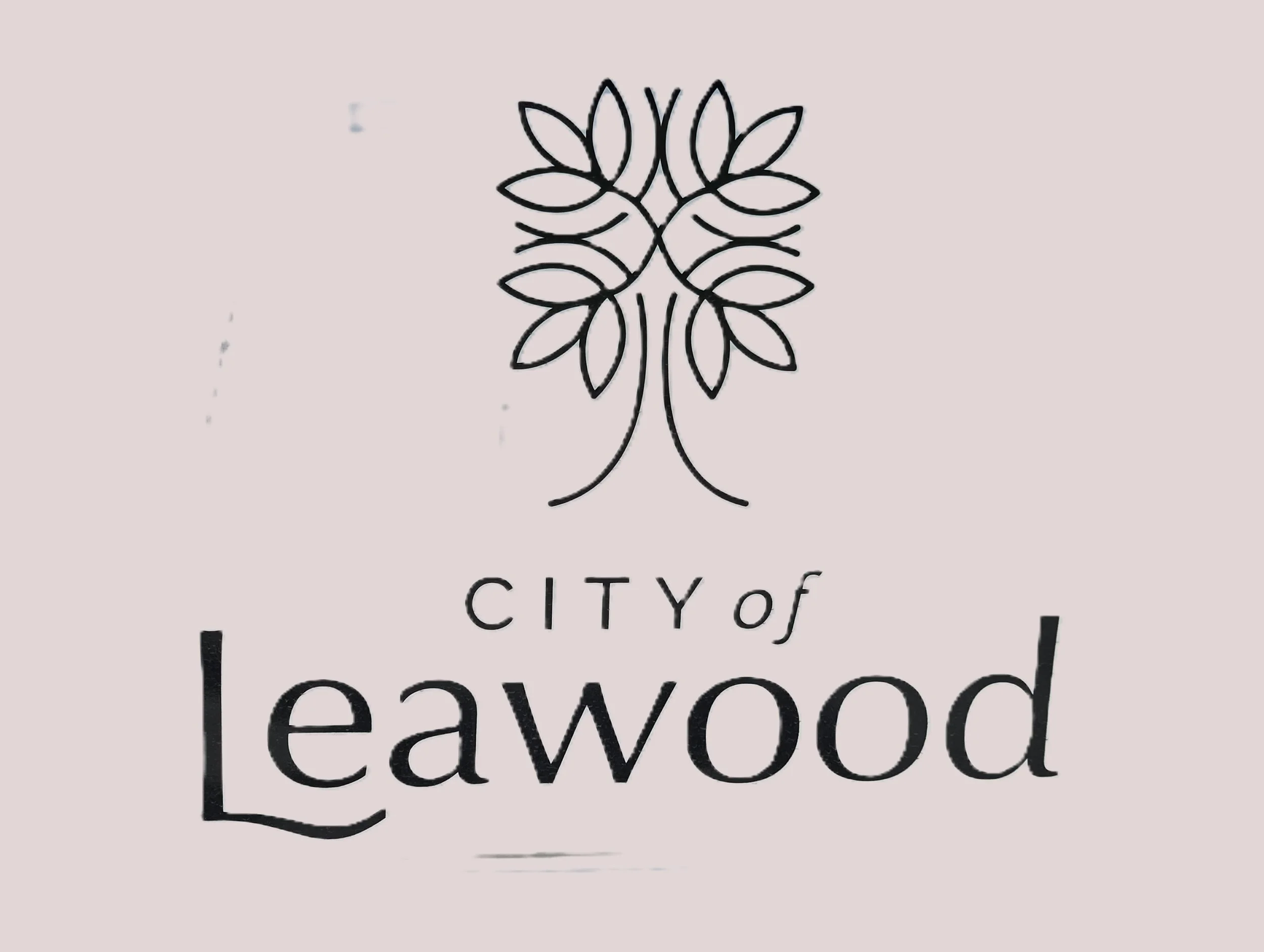 A logo consisting of a stylized tree with multiple leaves above the words "CITY of Lewwood" in black text.