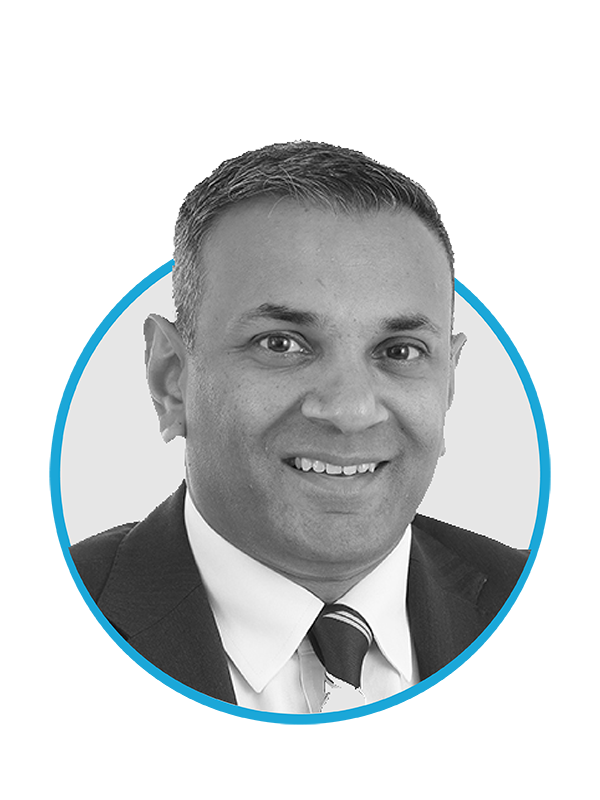 Black and white professional headshot of a man in a suit and tie, smiling, with a blue and black graphic background.
