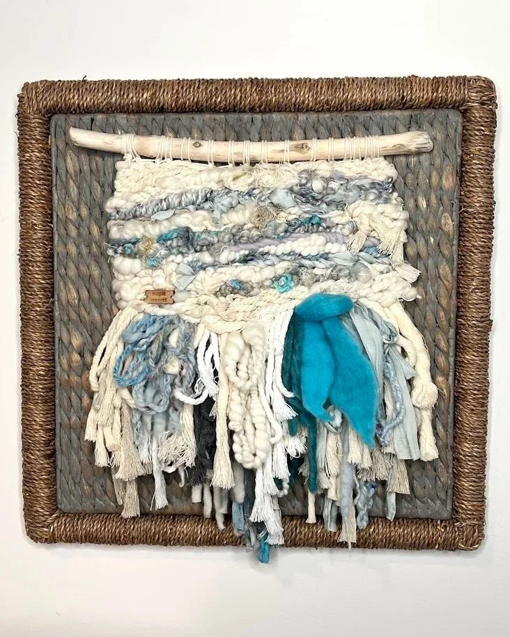 "Island Girl", Handwoven (Wool, handspun yarn, cotton, sari silk). Mounted on foraged driftwood in an 18" x 18" jute covered frame.  $550