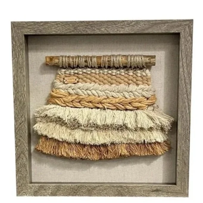 "Coconut Kiss", Handwoven (Cotton). Mounted in a 10" x 10" brown wooden frame without glass.  $160