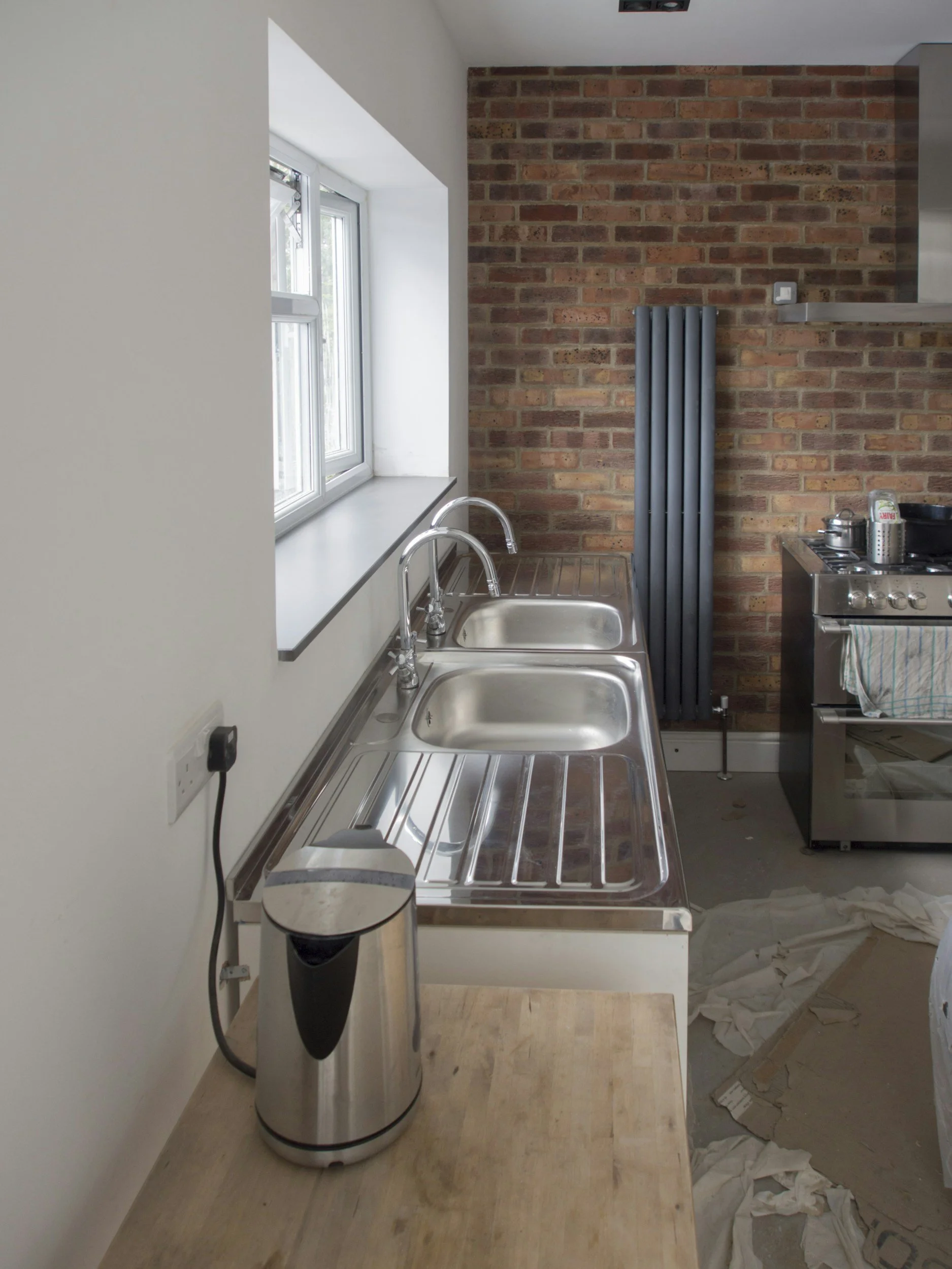 New kitchen cabinets being professionally installed by an experienced kitchen fitter in Surrey.