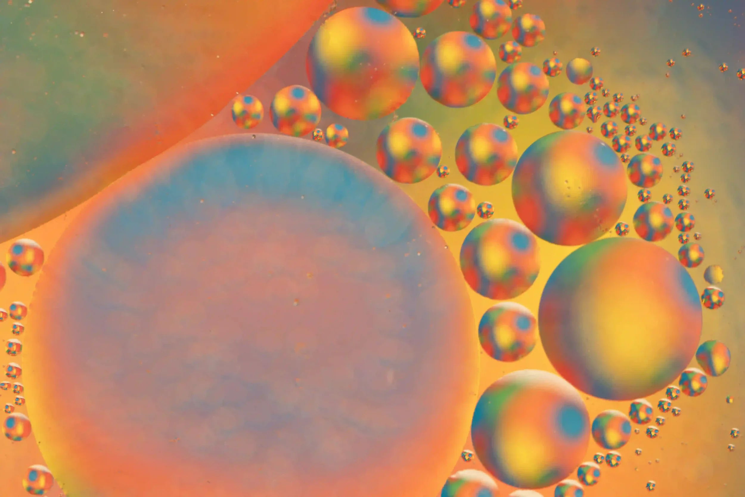 Energetic...
This photo brings such vibrant energy with it; multiplying and replaying the wonderful impact of bold colours from the single piece of art work under the surface. 
My own art work photographed under glass dish of water and oil droplets o