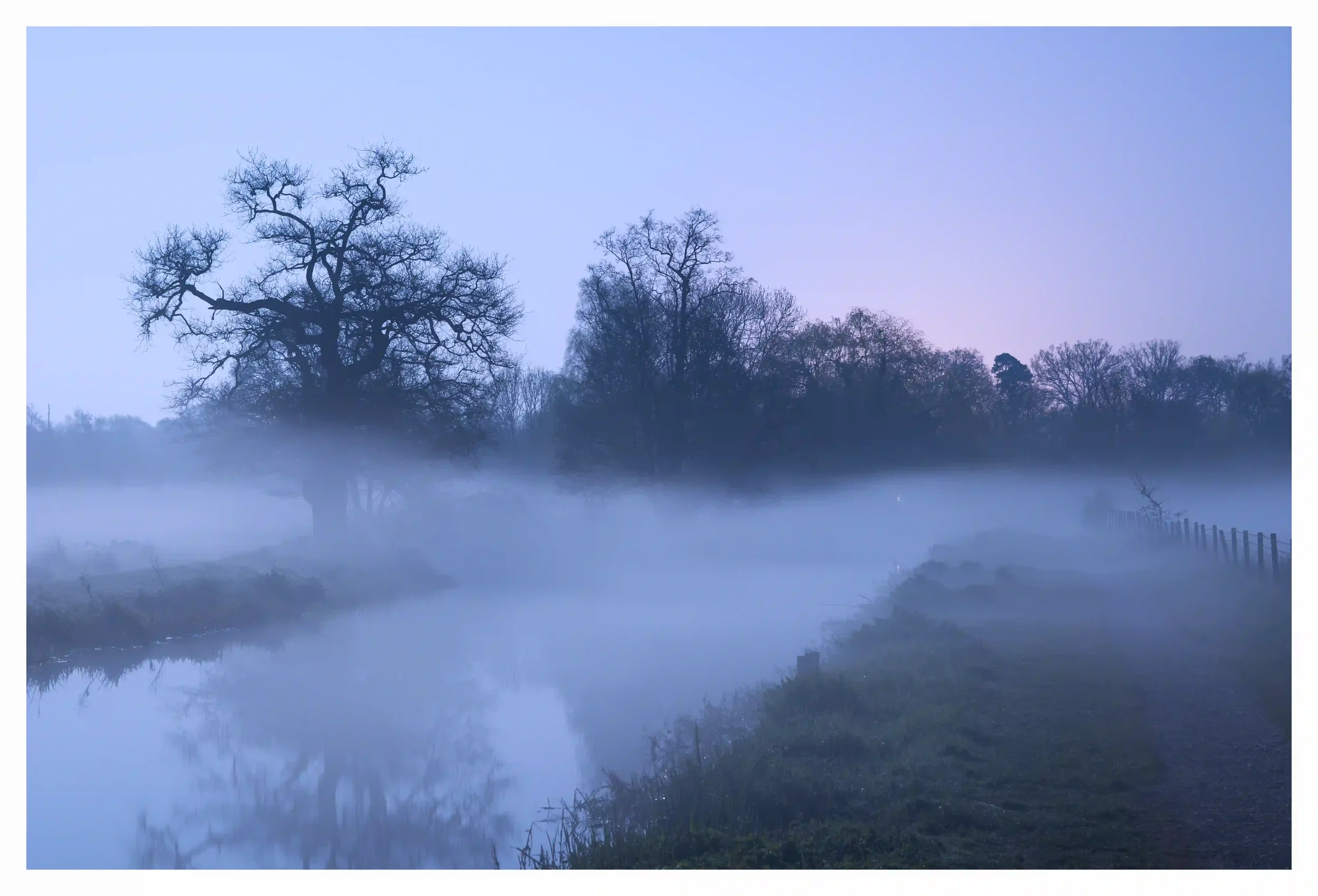 AN ETHEREAL GLOW
St Catherine's Lock, Guildford, Surrey, UK.
A fresh moonlit night as these low blankets of mist slowly appeared to delicately drift across the river. The atmosphere just feeling so calm and at ease as the two old riverside oaks would