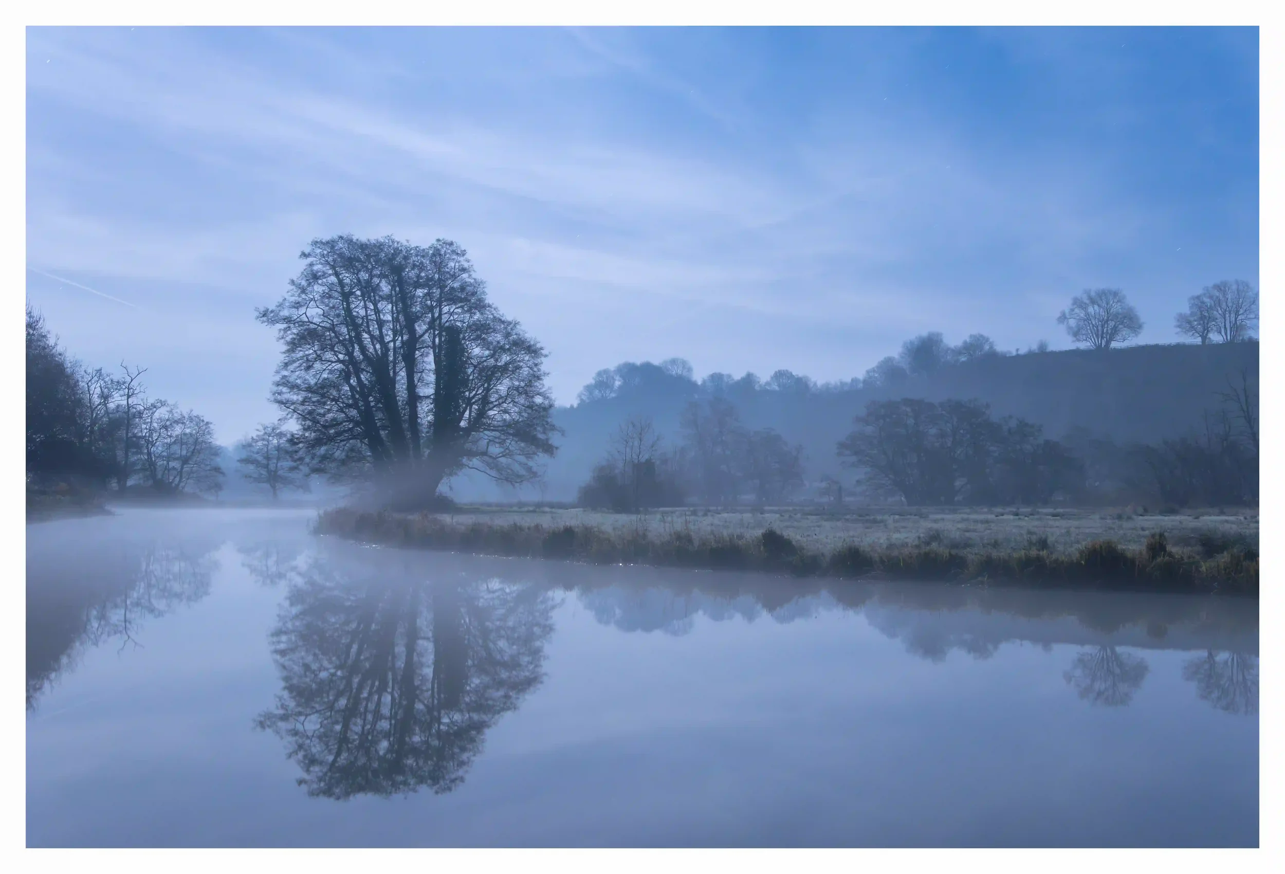 NOCTURNAL CALMNESS ON THE WEY
River Wey, Godalming, Surrey, UK.
Nearby roads had quietened down and so too did the number of walkers on this fresh December night. No breeze and a faint mist that had begun to slowly rise seemed to further soften the s