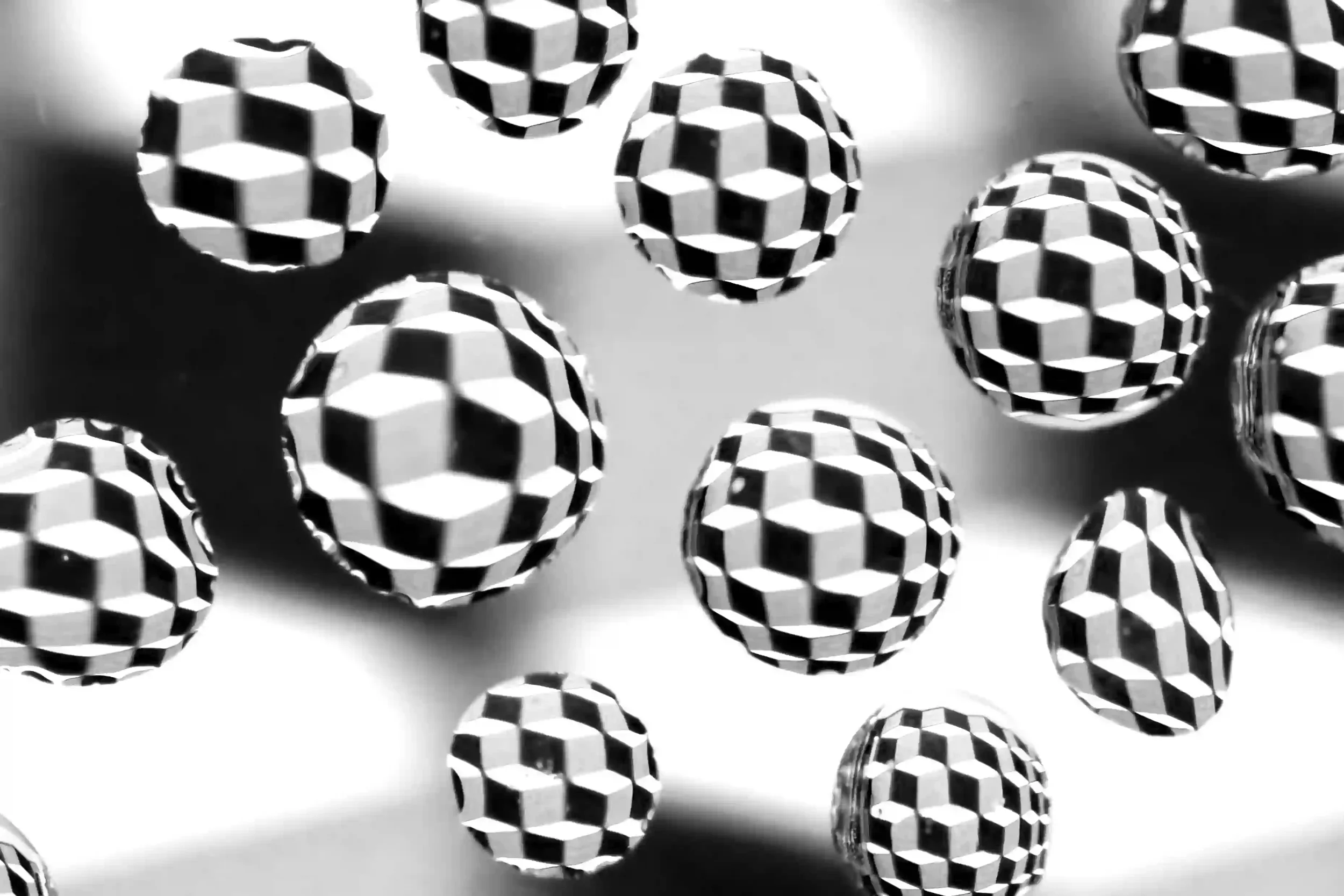 Cubed B&W...
Simplicity as what appears as building blocks form in their own little bubbles; their own little worlds. Cubes interact with the spheres.
My own art work, photographed under a sheet of glass with water droplets placed on top of it, proce