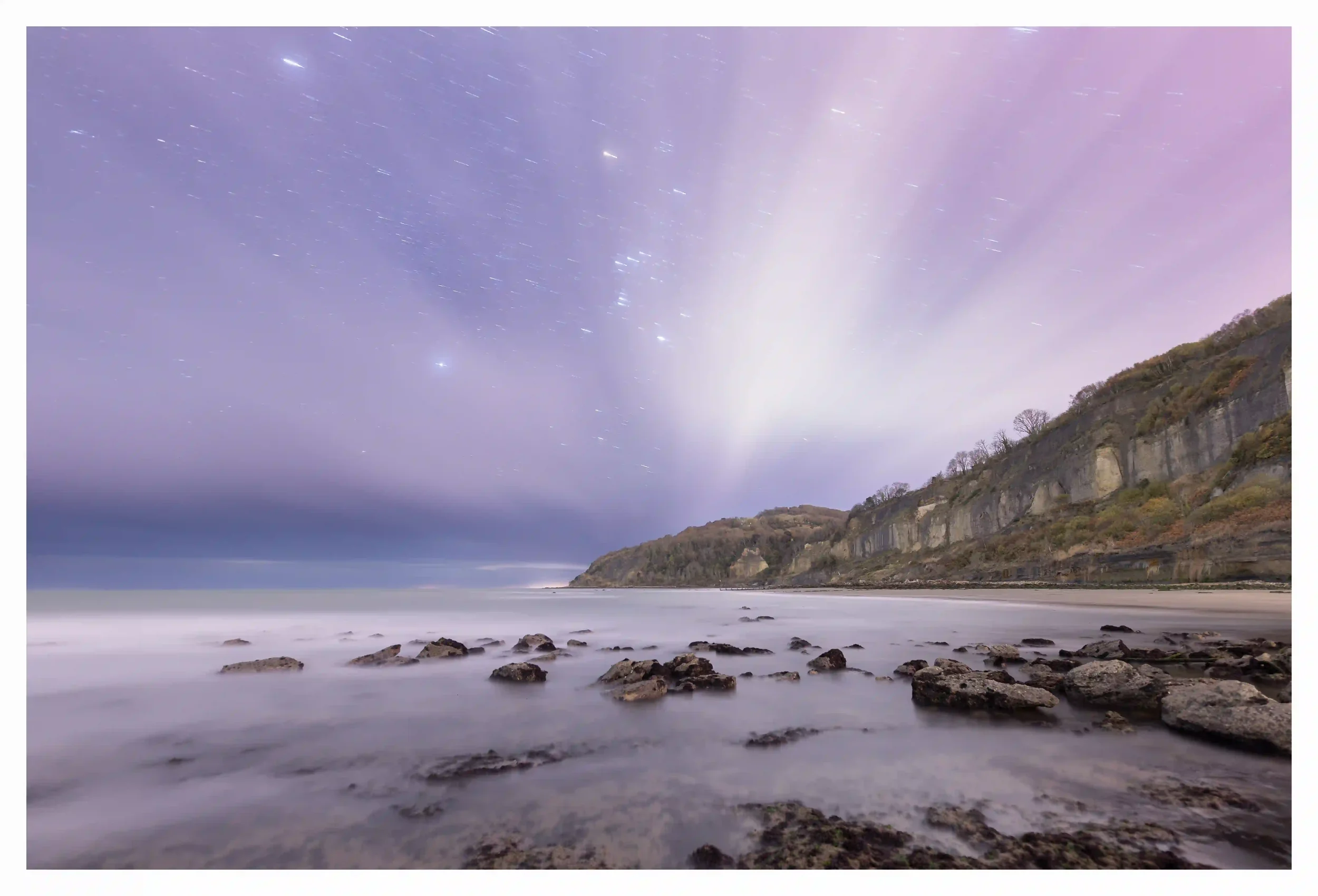 ECHOES OF RESILIENCE
The weathered characteristics of the cliffs and scattered rocks just seemed to be sitting so proudly under the forces of nature during the low tide on this night. Orion, despite the broken clouds, seemed to shine through proudly 