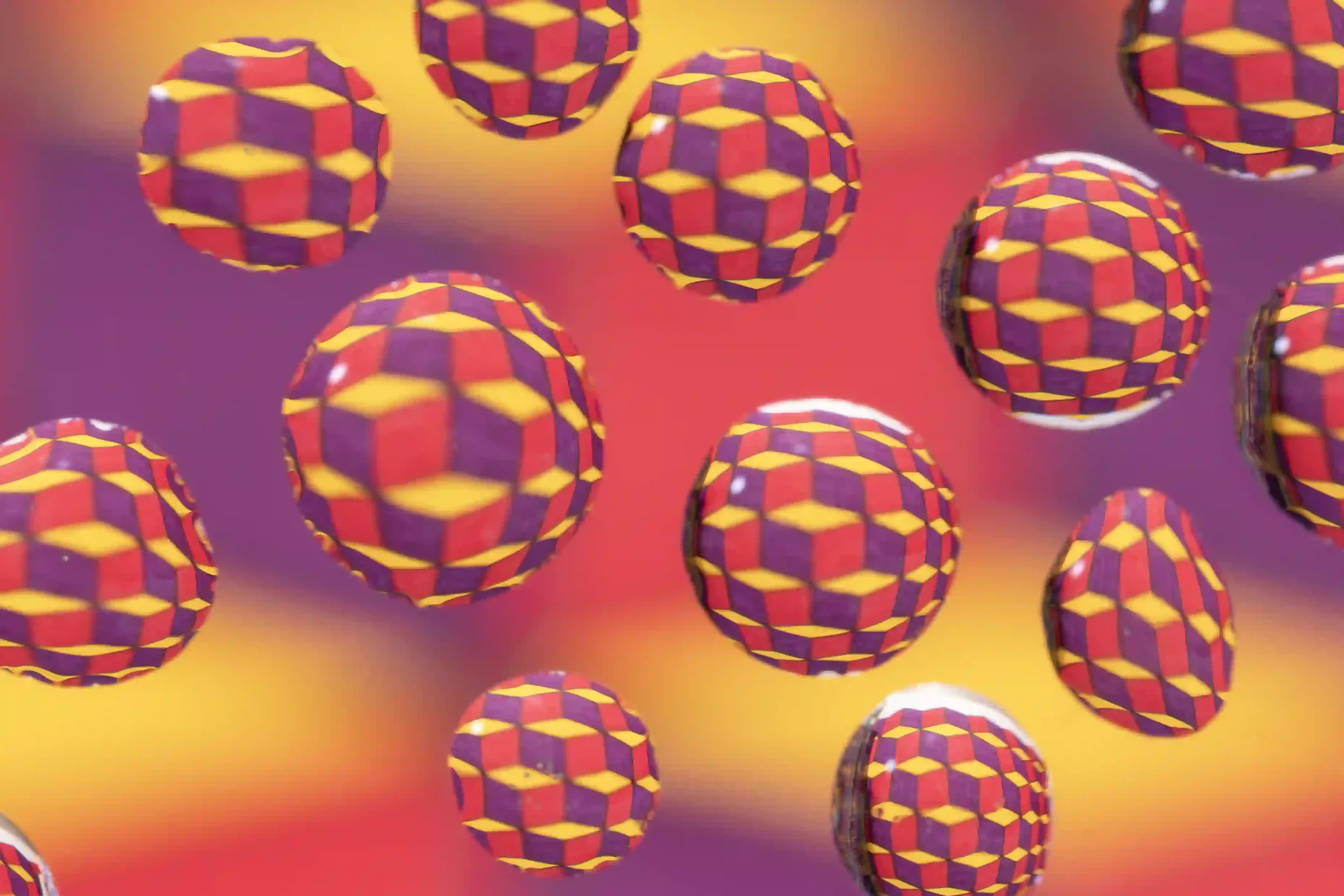 Cubed...
Cubes appear as if they are interacting with the spheres; what is initially one cubed wall is broken down into multiple sections, maybe even their own little worlds? 
My own art work, photographed under a sheet of glass with water droplets p
