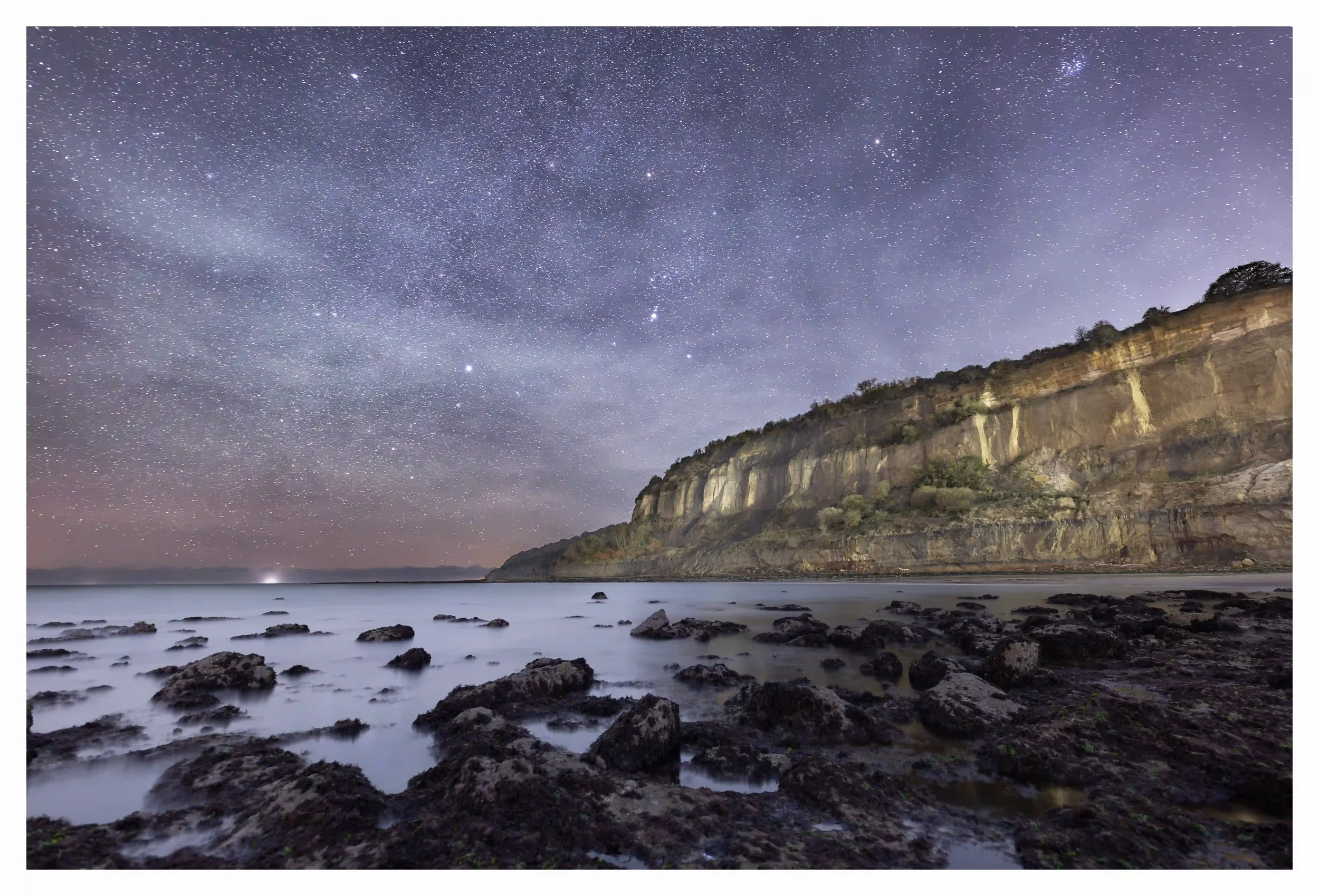 ORION OVER LUCCOMBE BAY ON MOONLIT NIGHT
The tide was temporarily fully out exposing a path that is not always walkable, allowing a brief encounter of looking back at the ancient coastline rocks as they stood boldly under the stars, 
Luccombe Bay, Is