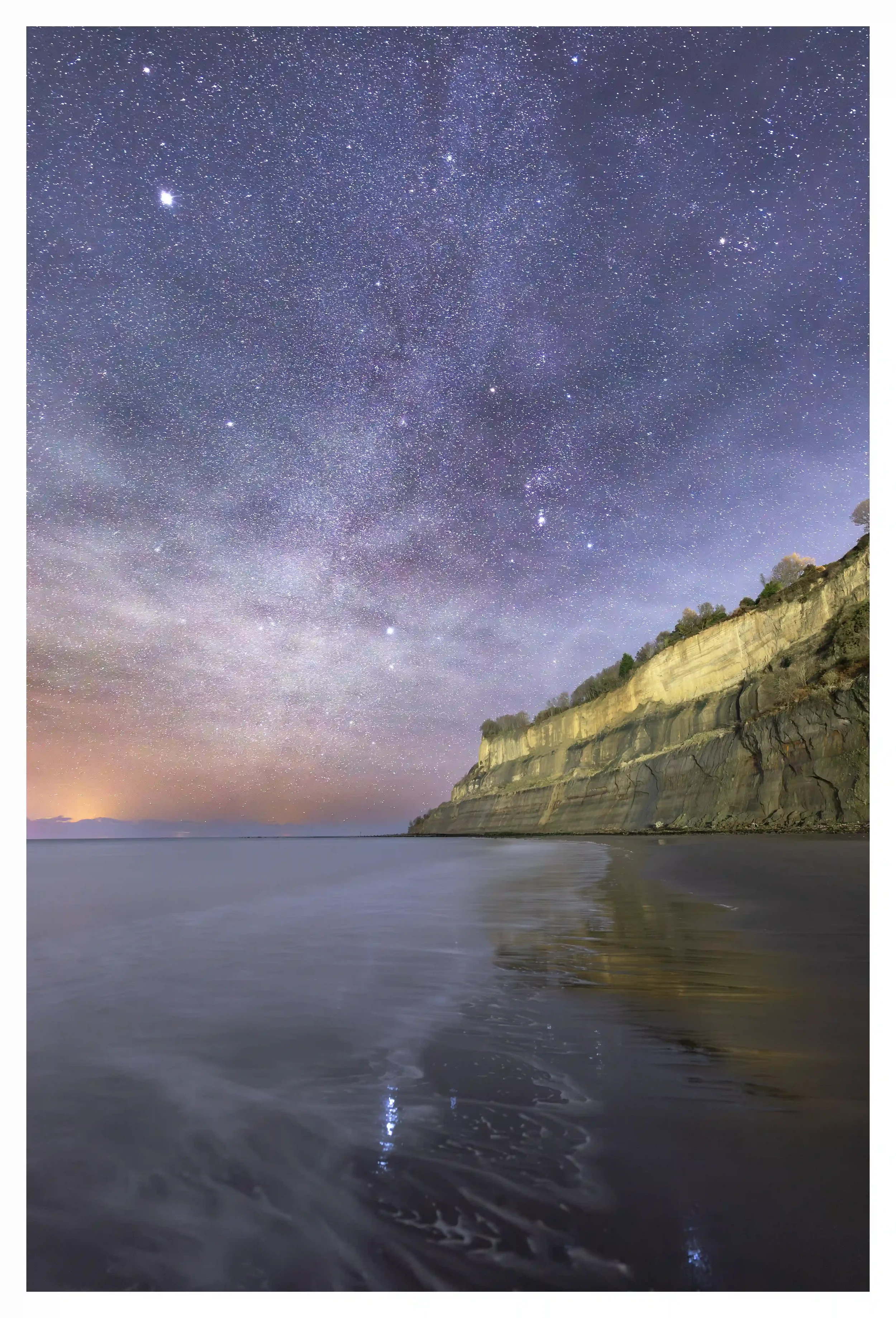 WHISPERING UNDER THE STARS
The tide was calmy coming back in on this night; the gentle sounds as if the waves were whispering with the sandy beachfront. Further adding to the peacefulness; the stars continued to softly twinkle all above me, as the ma