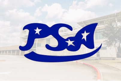 Large blue PSTA sign with stars, located on a street in front of a building with a curved roof and blue sky with clouds.