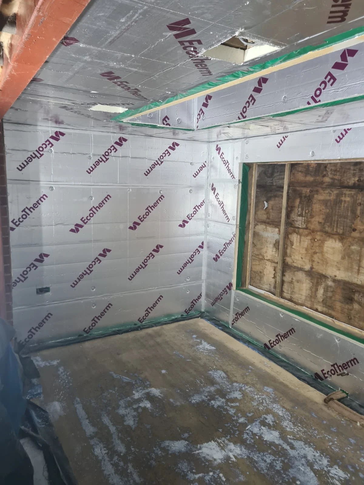 Building - fitting insulation and boarding walls.