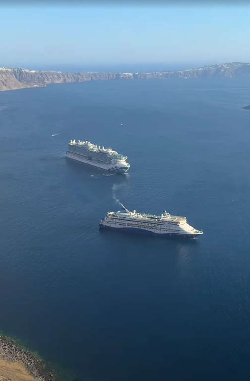 Caldera view with white cave houses and blue domes in Santorini, Greece