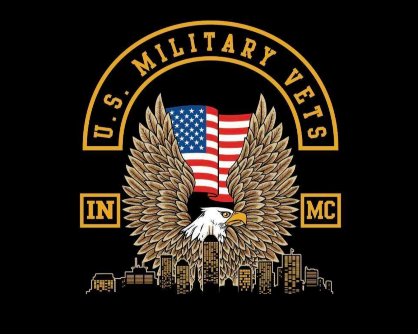 A logo with a bald eagle with outspread wings, holding a shield decorated with the American flag, and a city skyline below. The text 'U.S. Military Veterans' surrounds the eagle, with 'IN' on the left, 'MC' on the right, and the words above and below in a circular pattern.