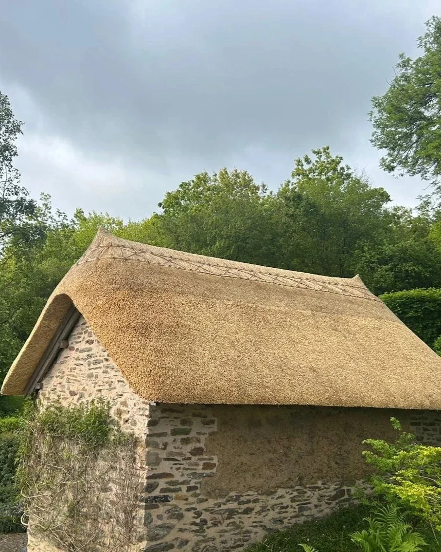 Traditional stone barn, thatched using combed wheat straw wit a flush butt up ridge.