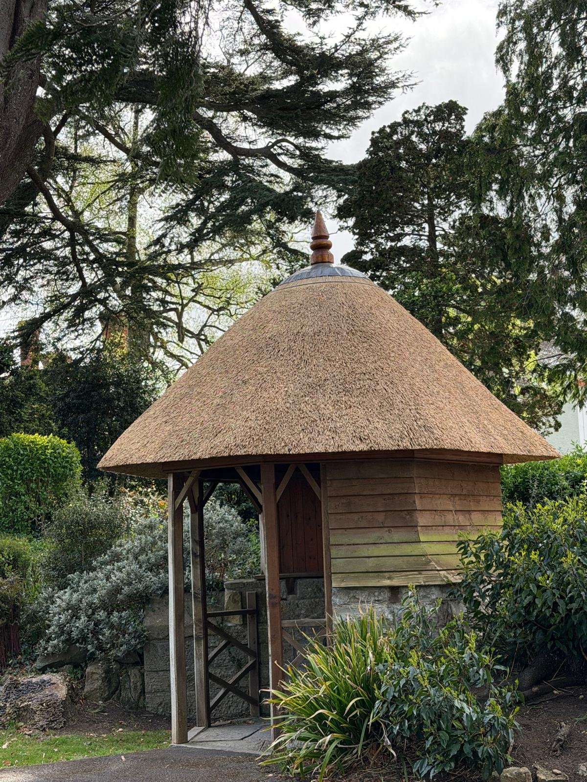 A gazebo thatched in water reed finished with a lead cap