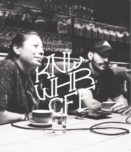 Two people sitting at a bar, one woman and one man, with drinks in front of them, in a black-and-white photo. Overlayed is logomark for KWC Know Where Coffee Roasters