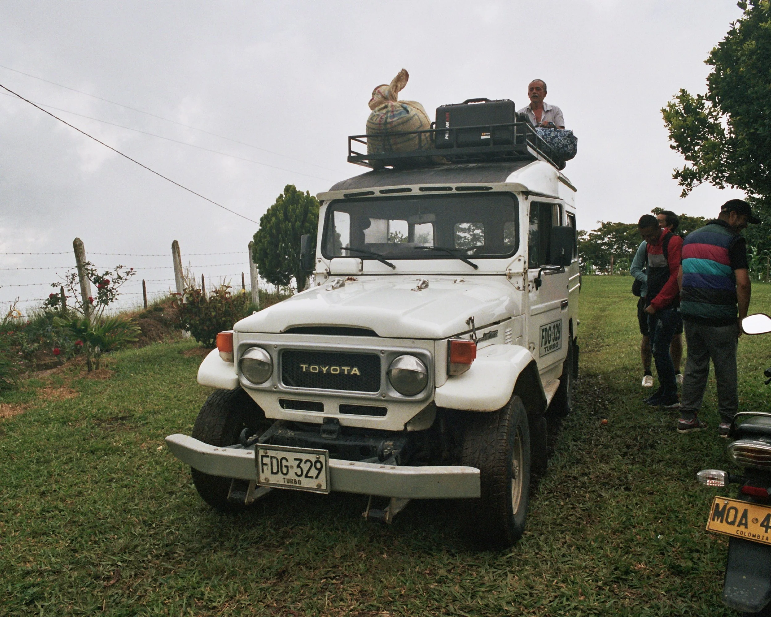 White Toyota pickup truck at origin in Colombia transporting jute bags of specialty microlot Colombia coffee