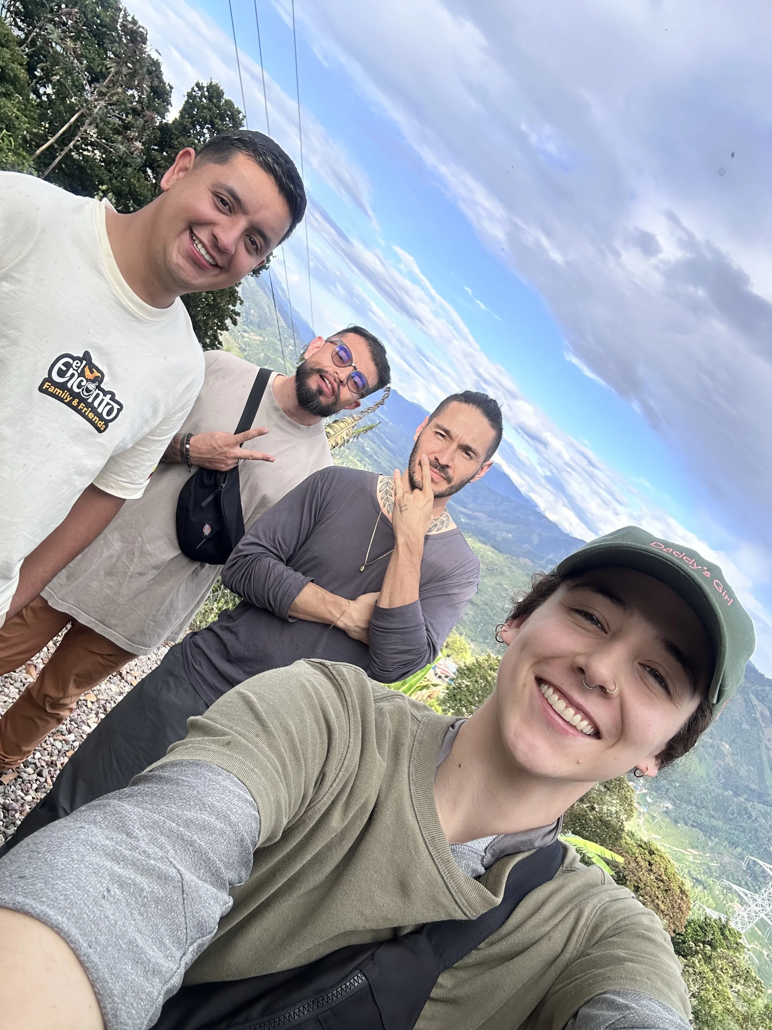 Team members of KWC Roasting, Green Importing, Wholesale, Retreats on site at Finca El Encanto specialty Colombia Coffee. View of Pitalito, Huila in the background.