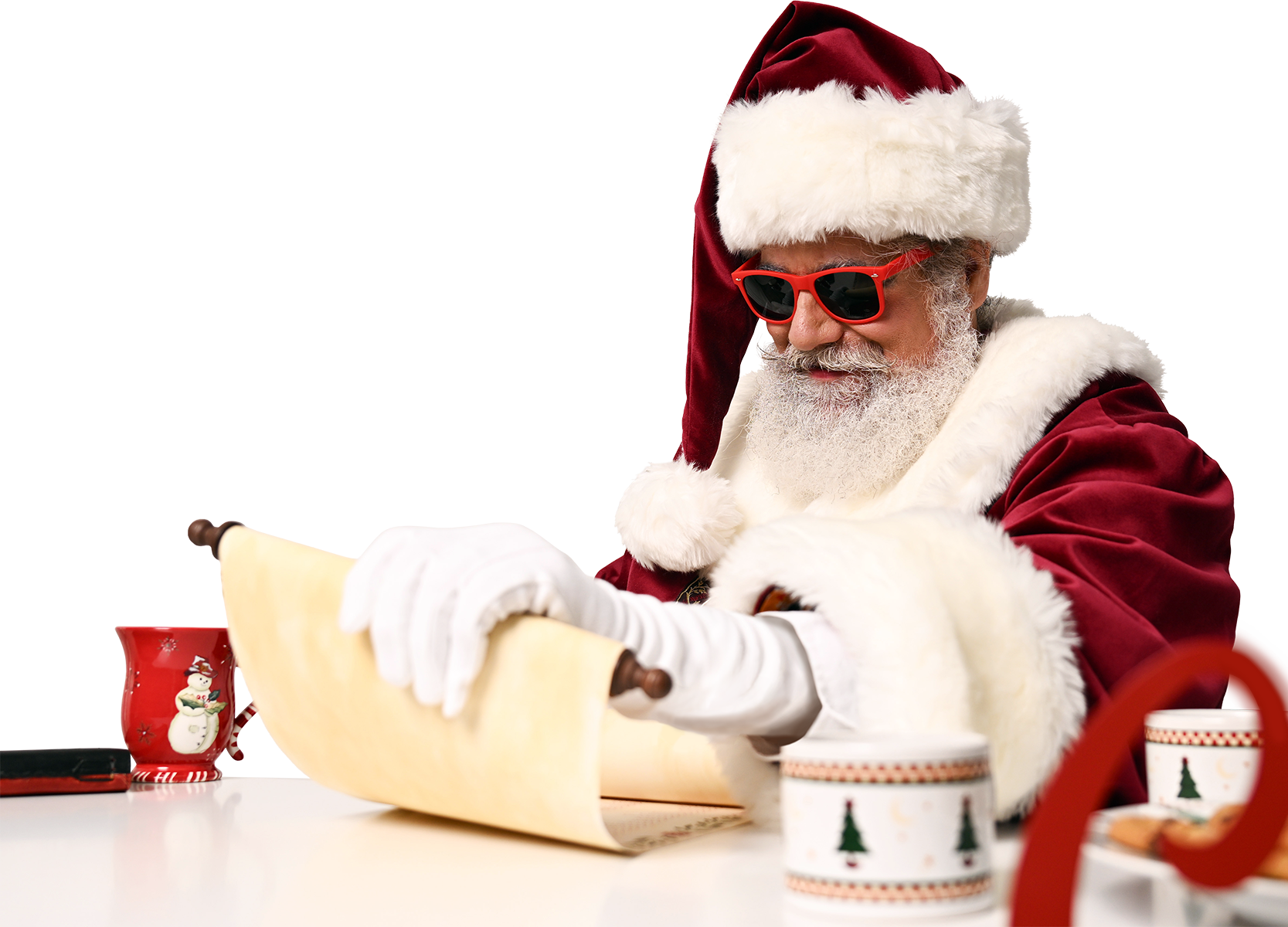 Santa Claus wearing sunglasses, reading a scroll, in a festive setting with holiday mugs and decorations.