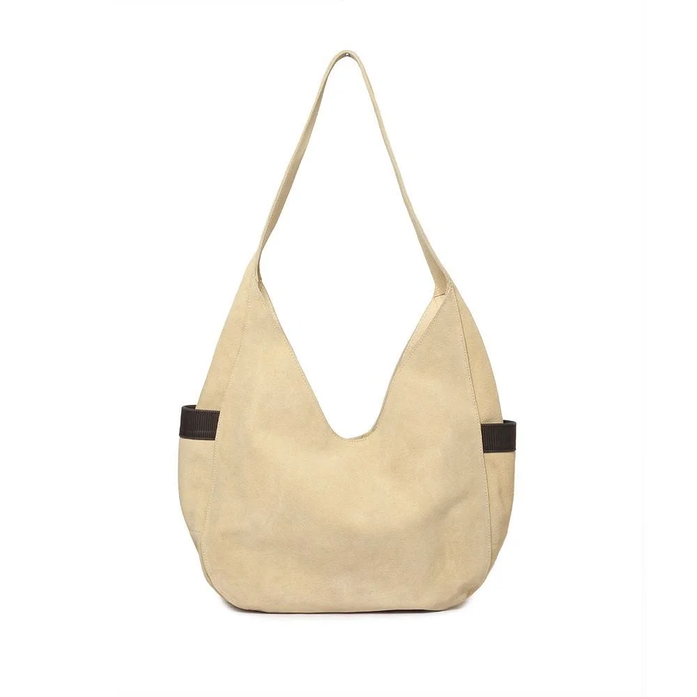 Bolsa beige con asas largas y bolsillos laterales oscuros.