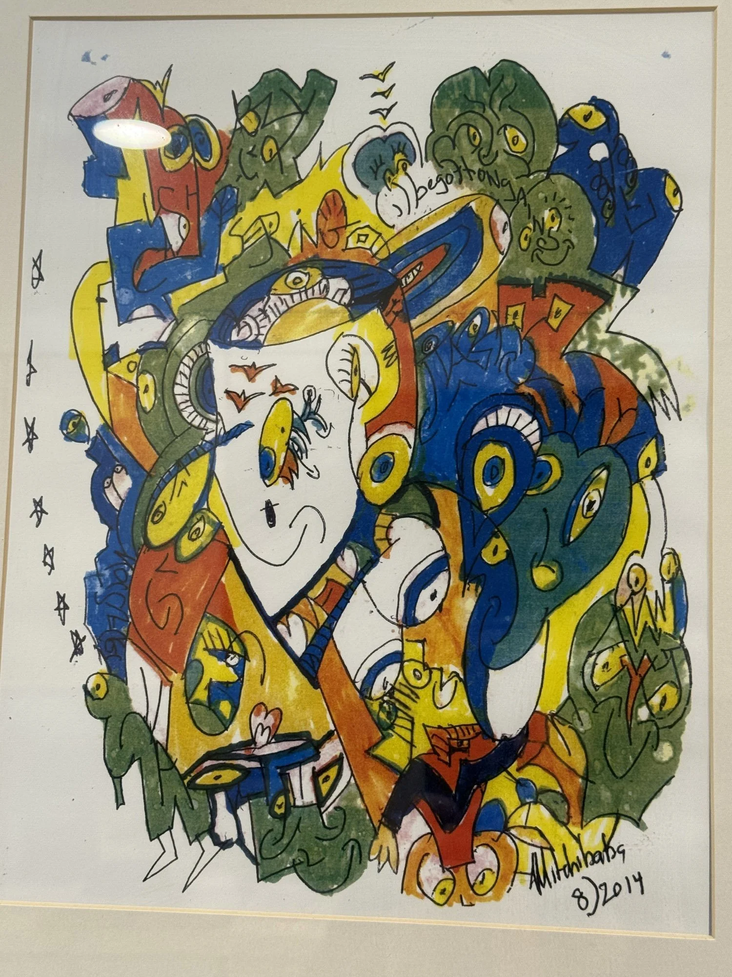 Colorful abstract drawing of multiple faces, eyes, and various shapes with vibrant colors including yellow, blue, red, green, and orange. Contains handwritten text and a signature with date.