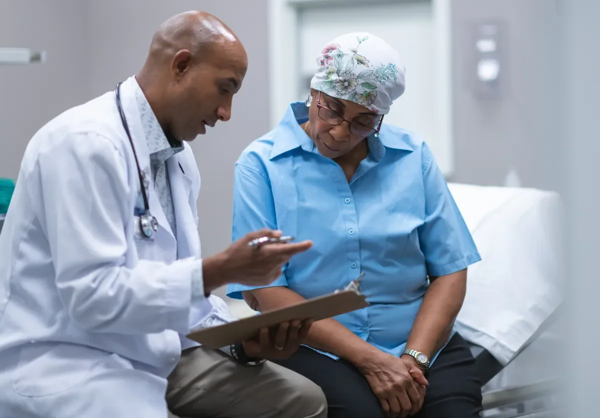 black male doctor with a black elder female patient