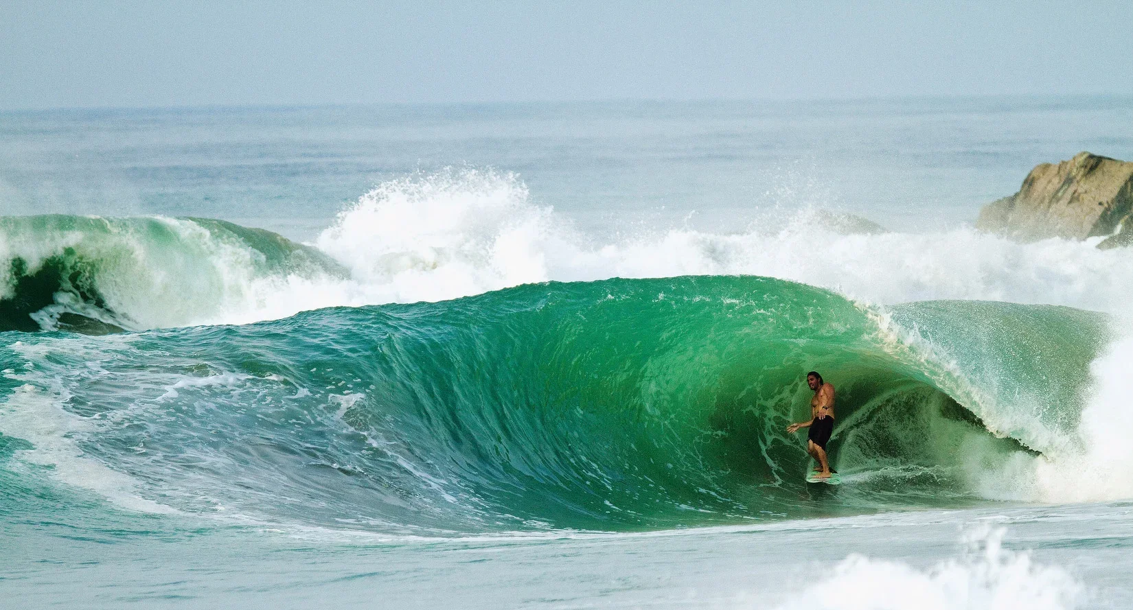 Surfer getting barreled at a beach break in Salina Cruz, Mexico