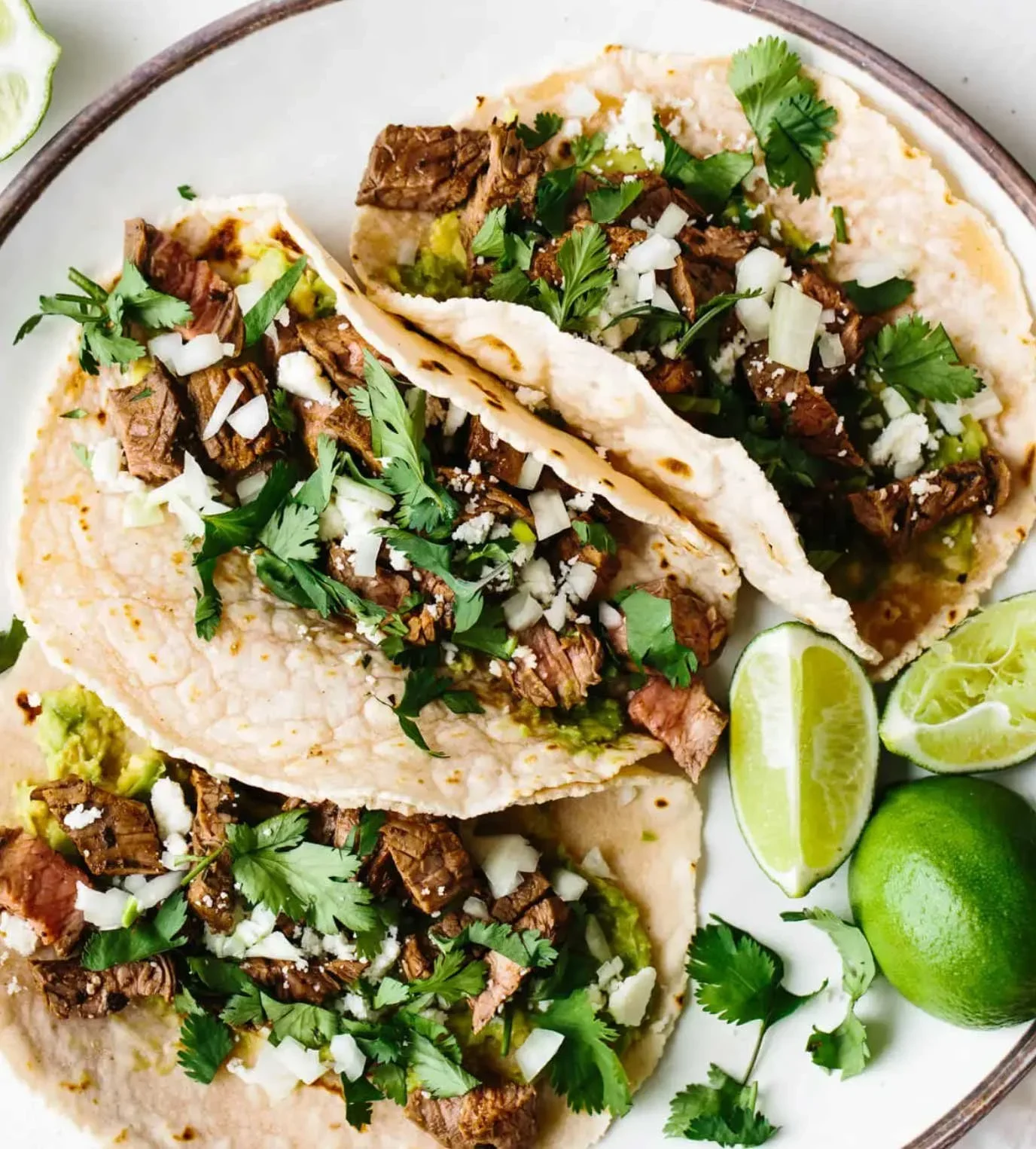 Plate of tacos with lime wedges, local food near the surf camp