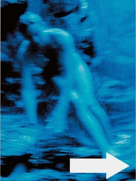 Blurred blue-toned abstract image of a human figure with a white arrow pointing to the right.