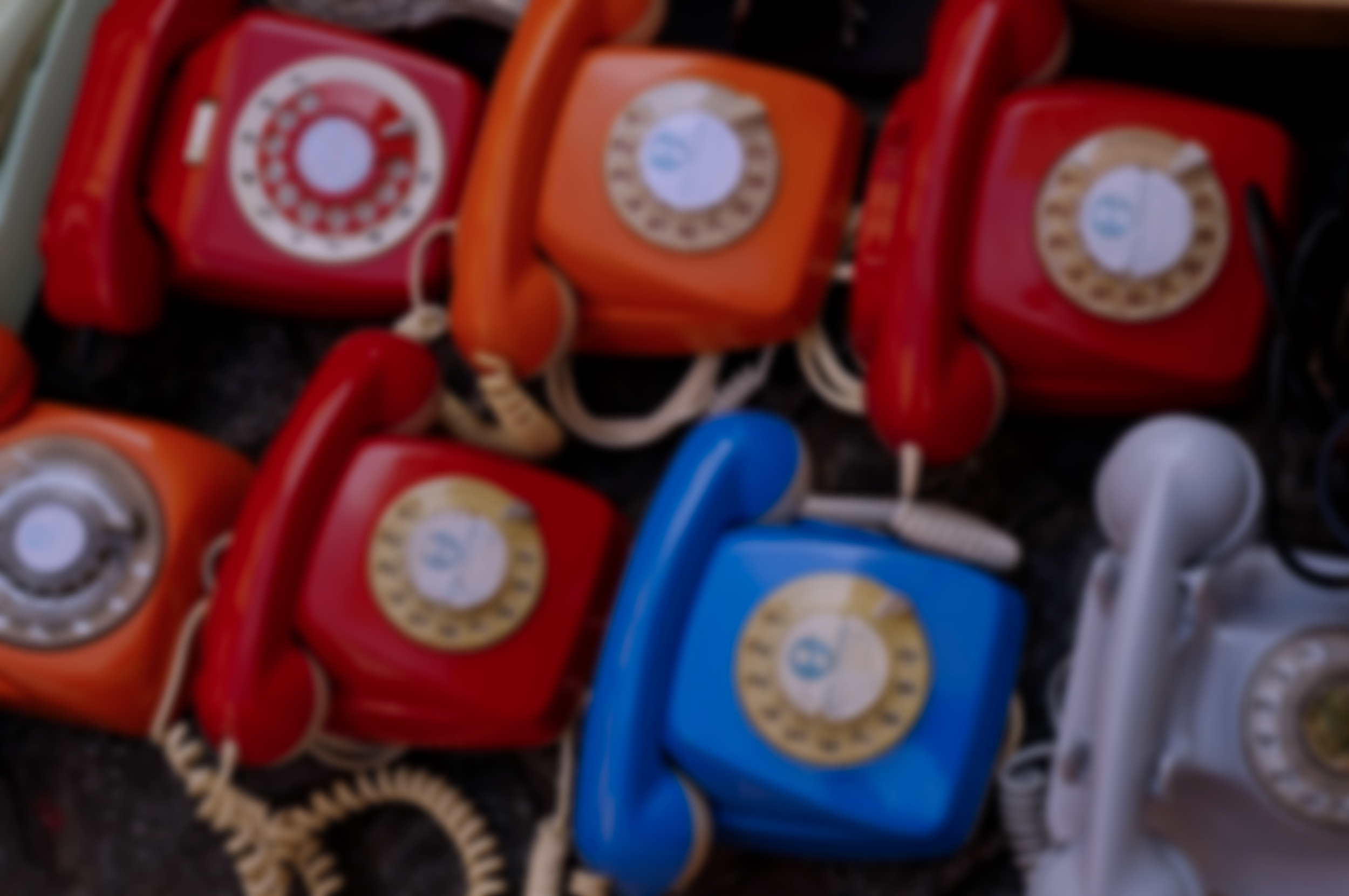 Vintage rotary telephones representing personalized client communication at Wyld Sol Body Sugaring Calgary.