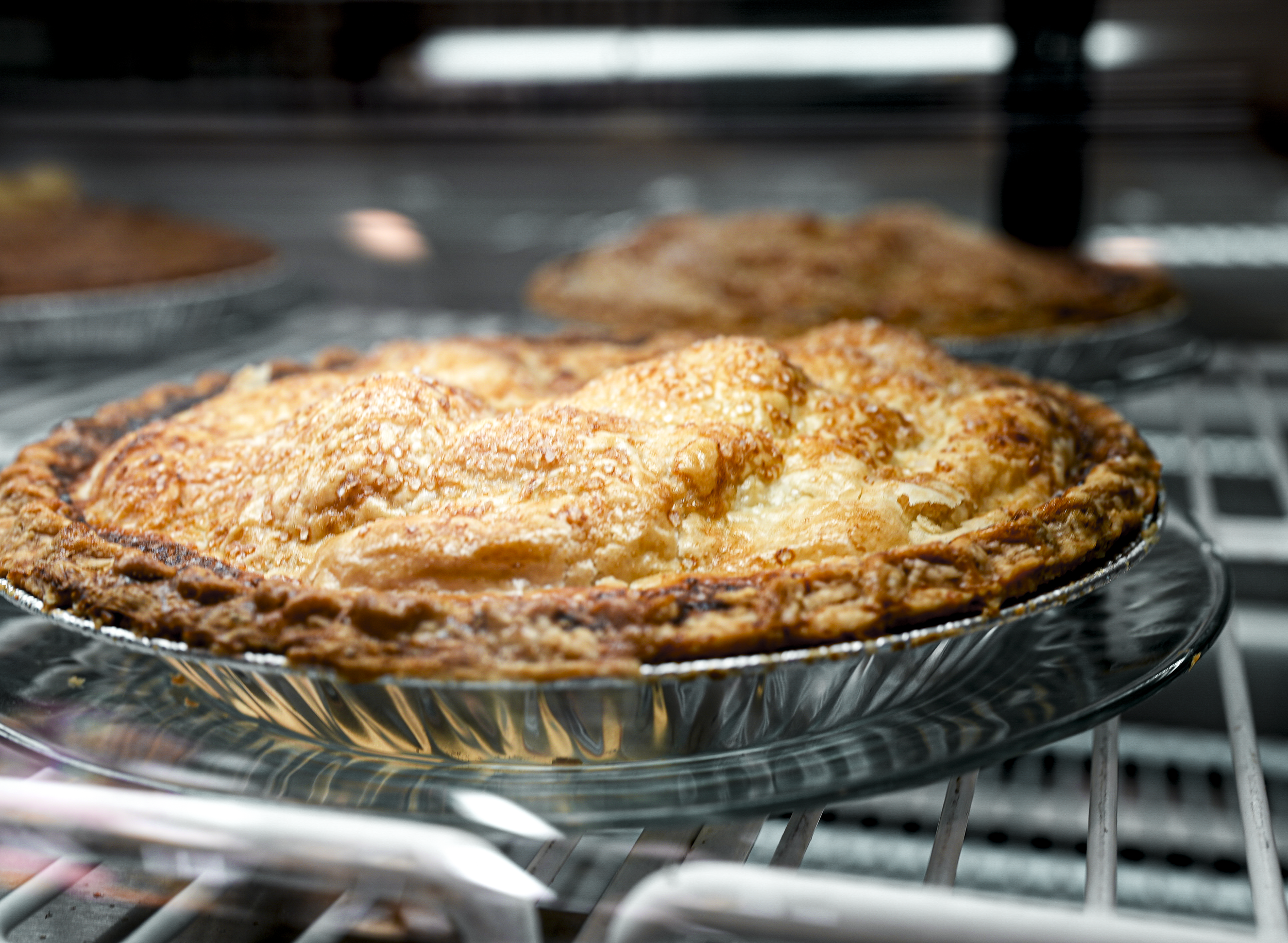 A cheesy baked dish with a golden-brown crust atop, baking in an oven.