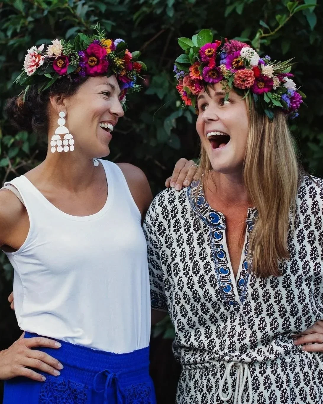 Two women wearing colorful flower crowns after flower arranging workshop at Rocklands Farm Winery
