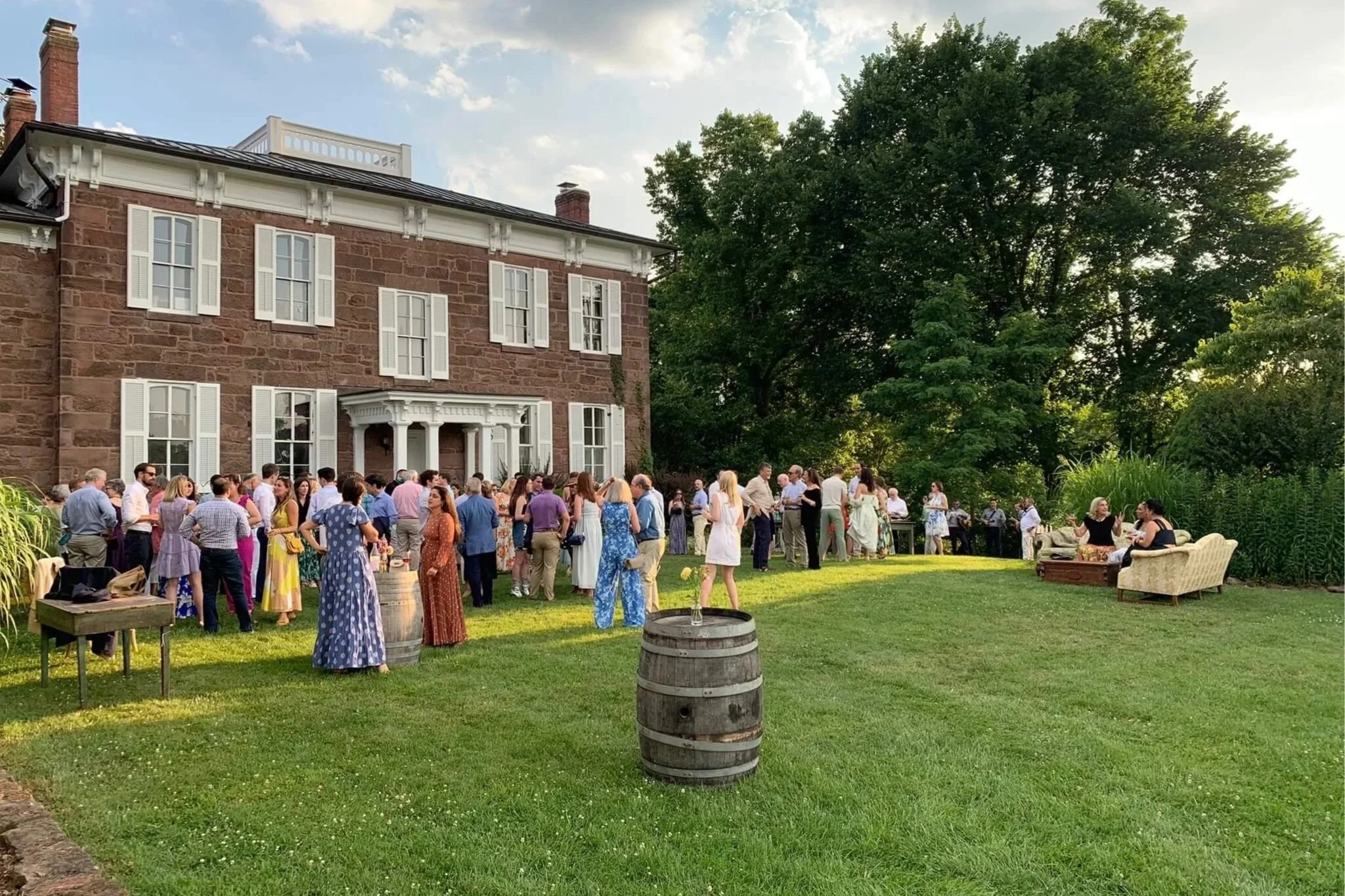 Guests gathering outside the historic brick house at Rocklands Farm Winery for a private, corporate event.
