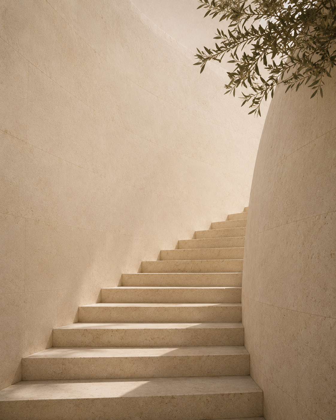 A staircase with beige stone steps surrounded by beige walls, with sunlight and a green tree branch visible at the top right corner.